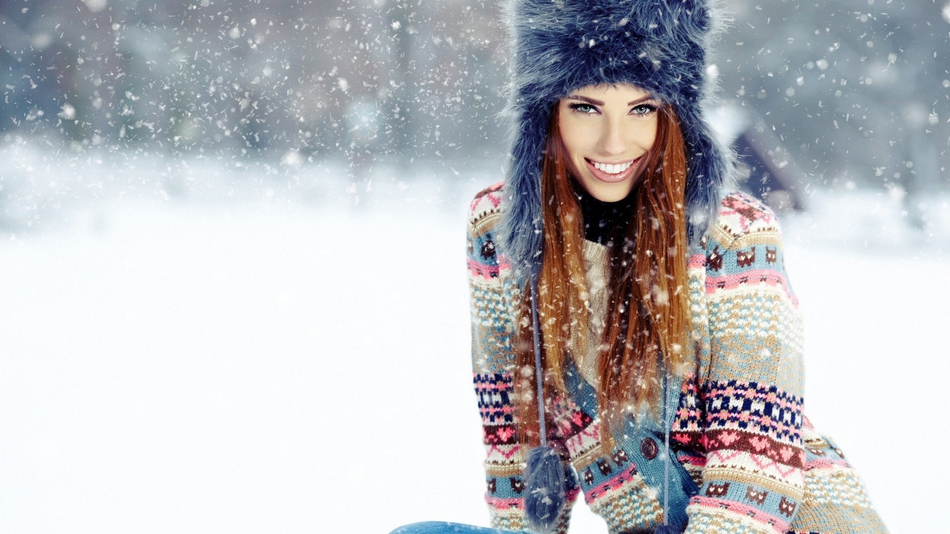 Woman in winter hat and patterned sweater in snow HD Wallpaper