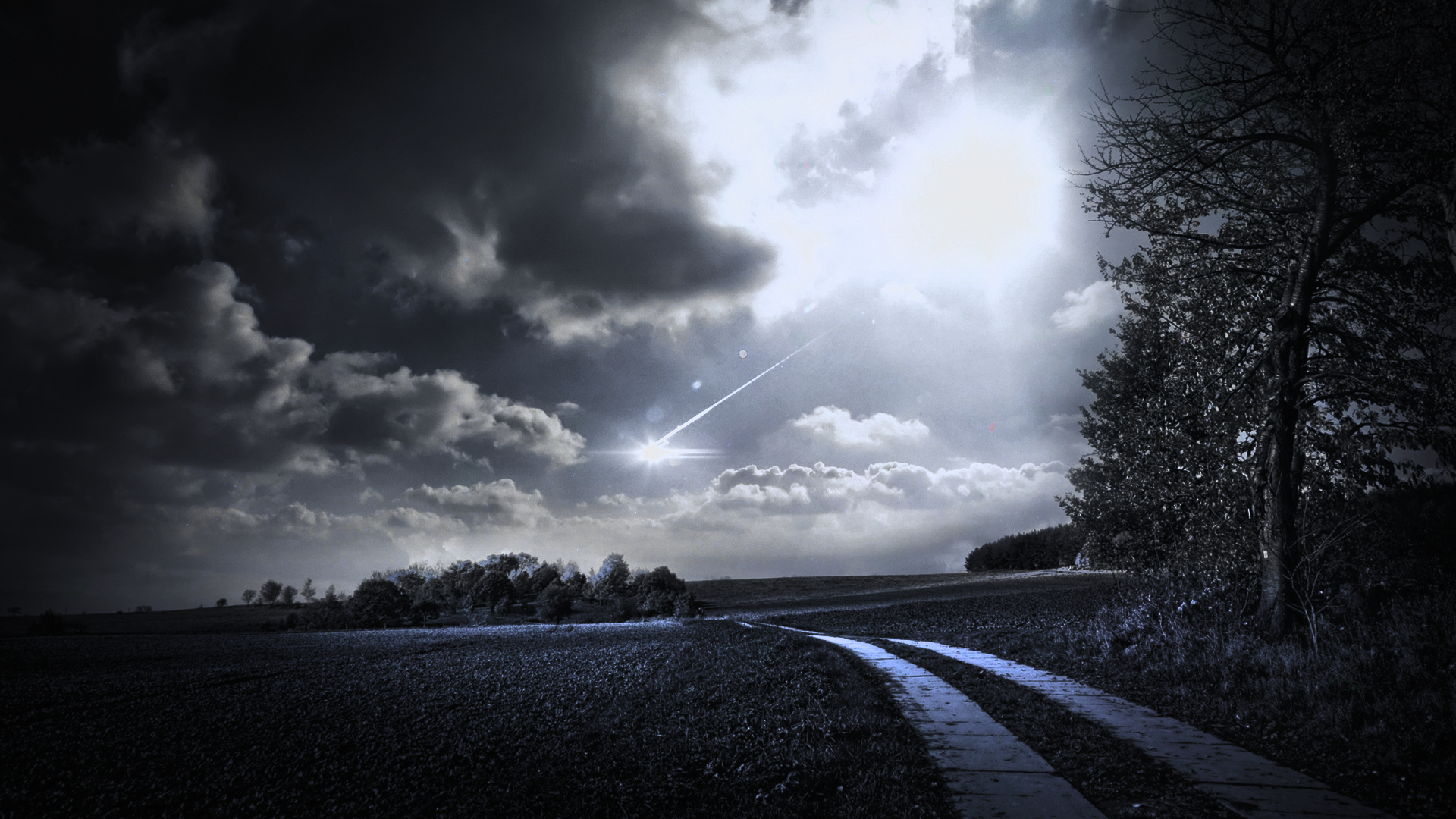 Meteor shower over a dark landscape with a dirt road HD Wallpaper