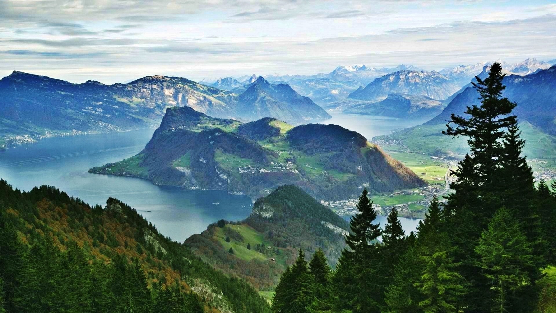 Mountainous landscape with a lake and evergreen trees HD Wallpaper