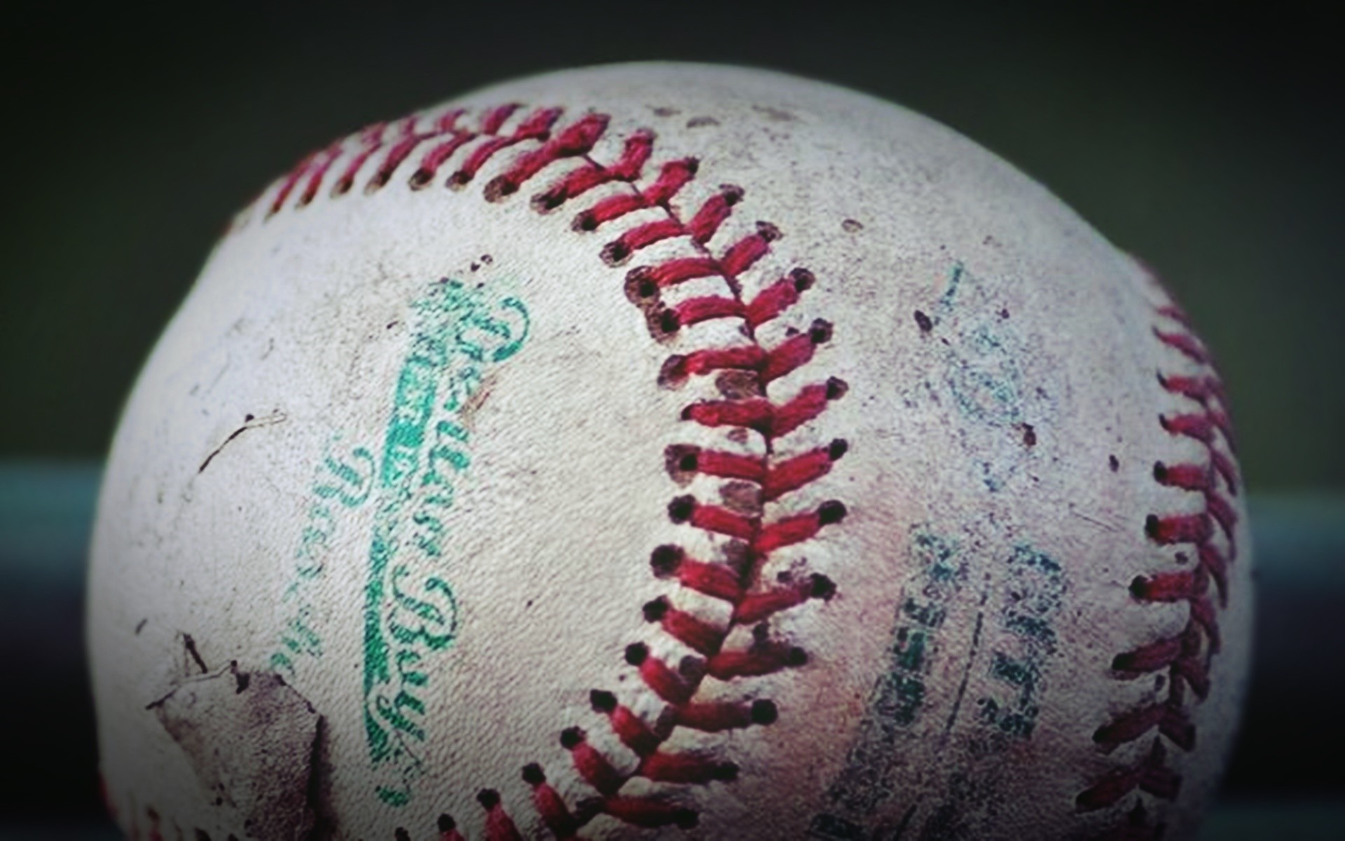 Close up of a worn baseball with red stitching HD Wallpaper