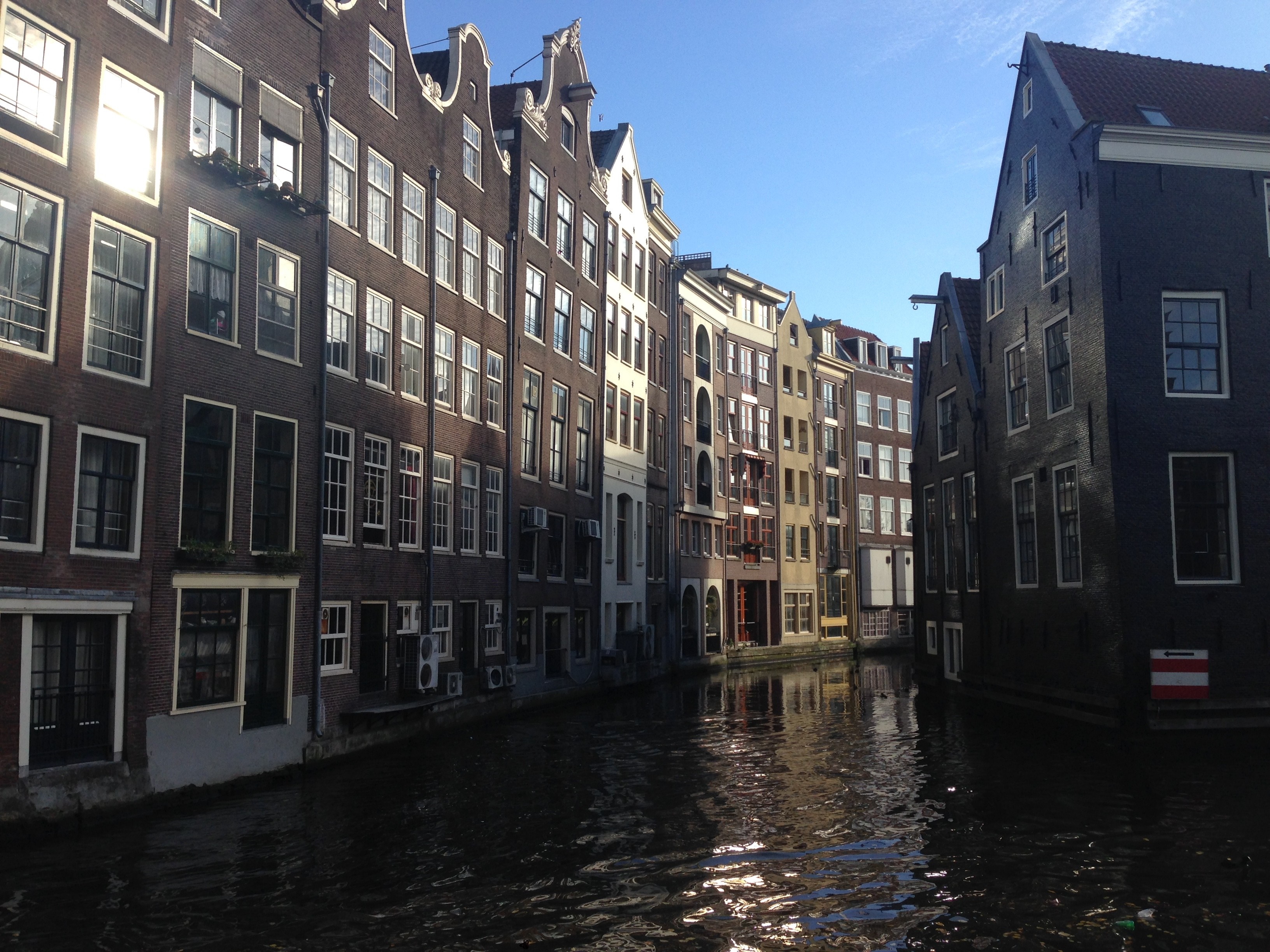 Amsterdam canal with historic buildings and reflections HD Wallpaper