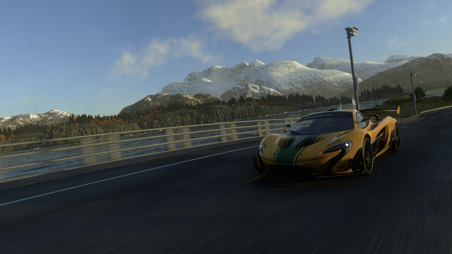 McLaren P1 driving on a road with mountains HD Wallpaper