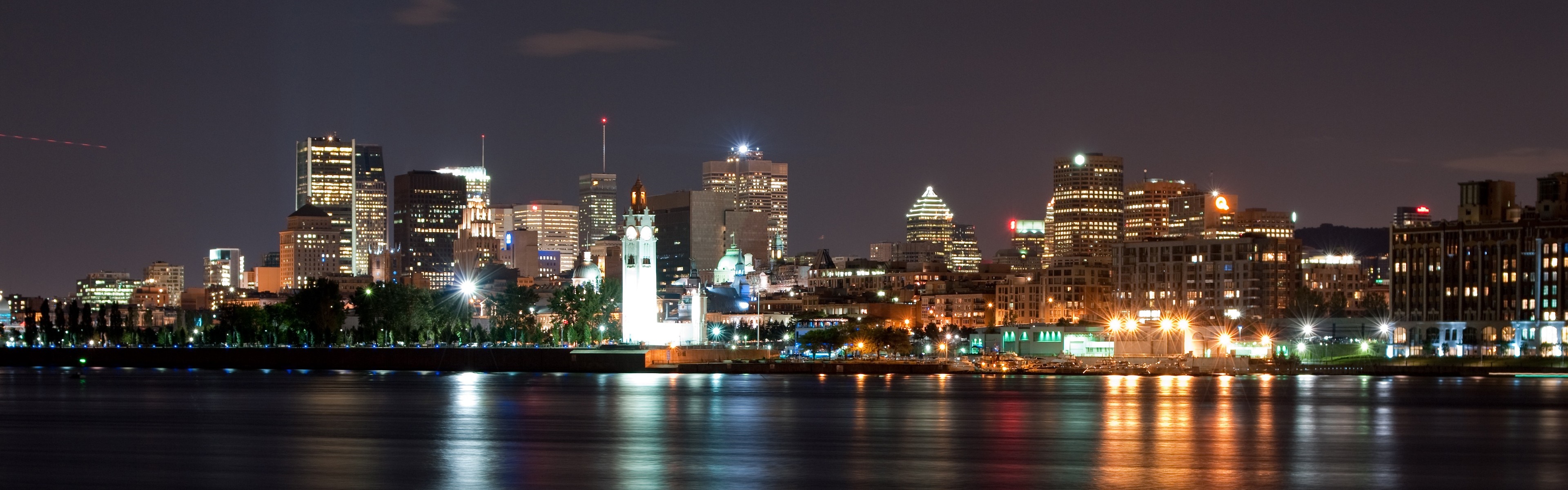 Montreal skyline at night with reflections on the water HD Wallpaper