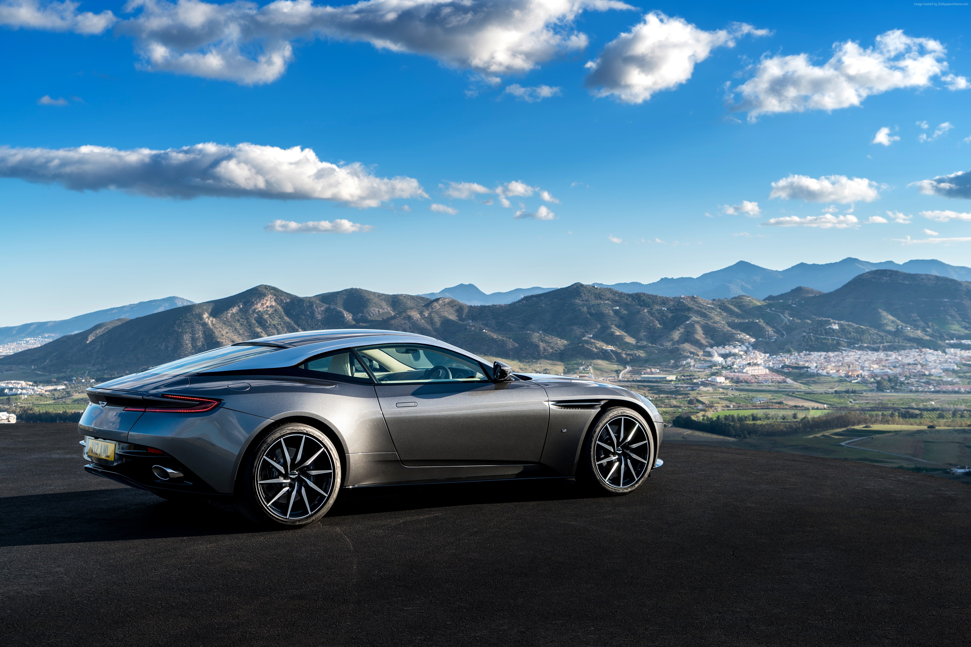Aston Martin DB11 parked on a hill overlooking a town HD Wallpaper