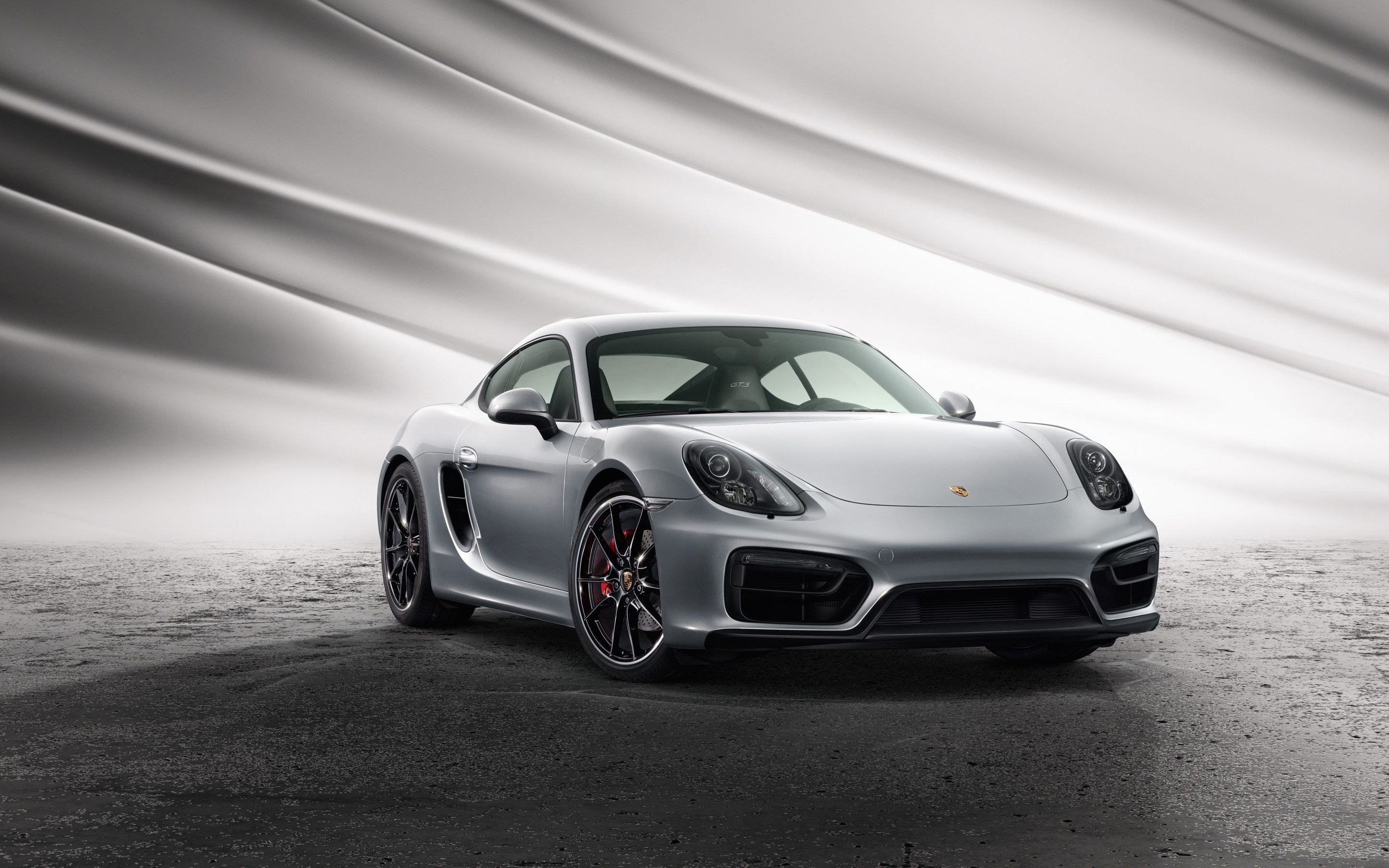 Silver Porsche Cayman S parked on a textured surface HD Wallpaper