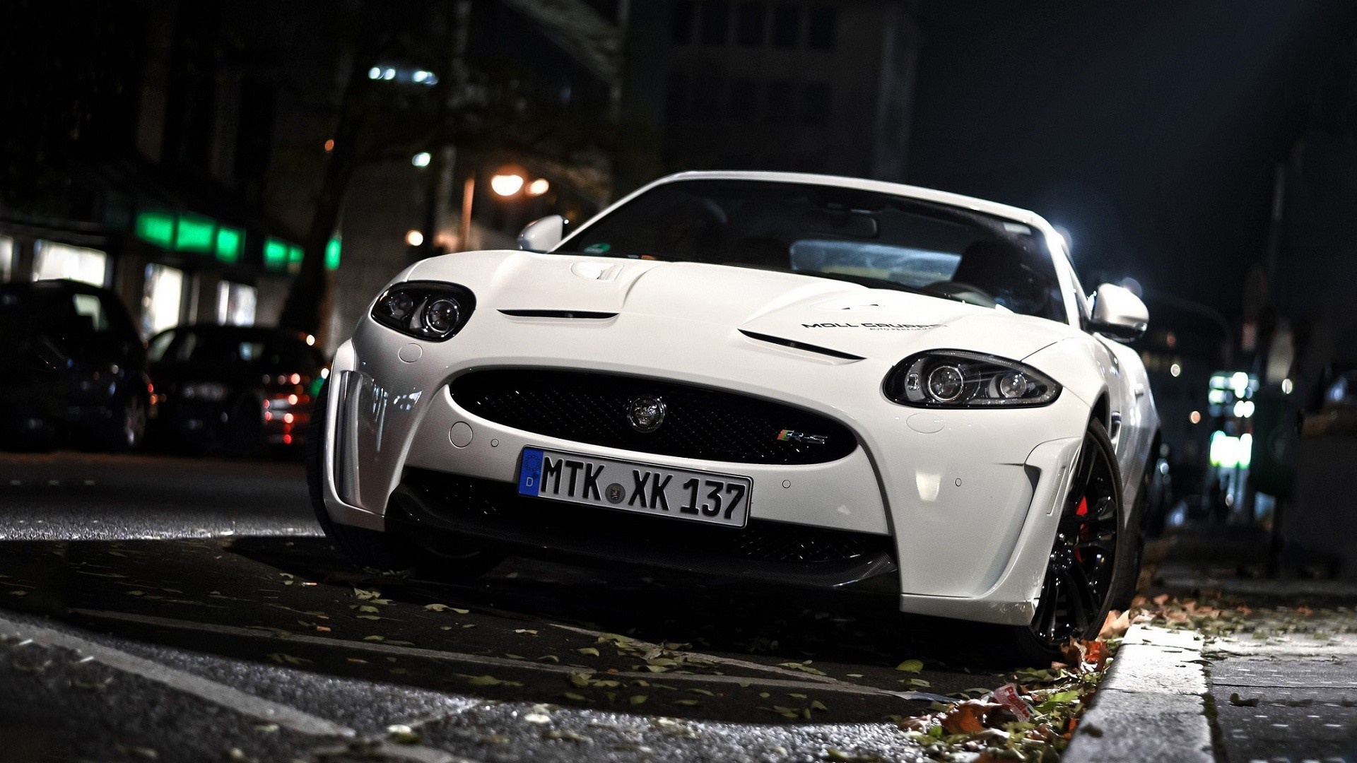 White Jaguar XKR S parked on a city street at night HD Wallpaper