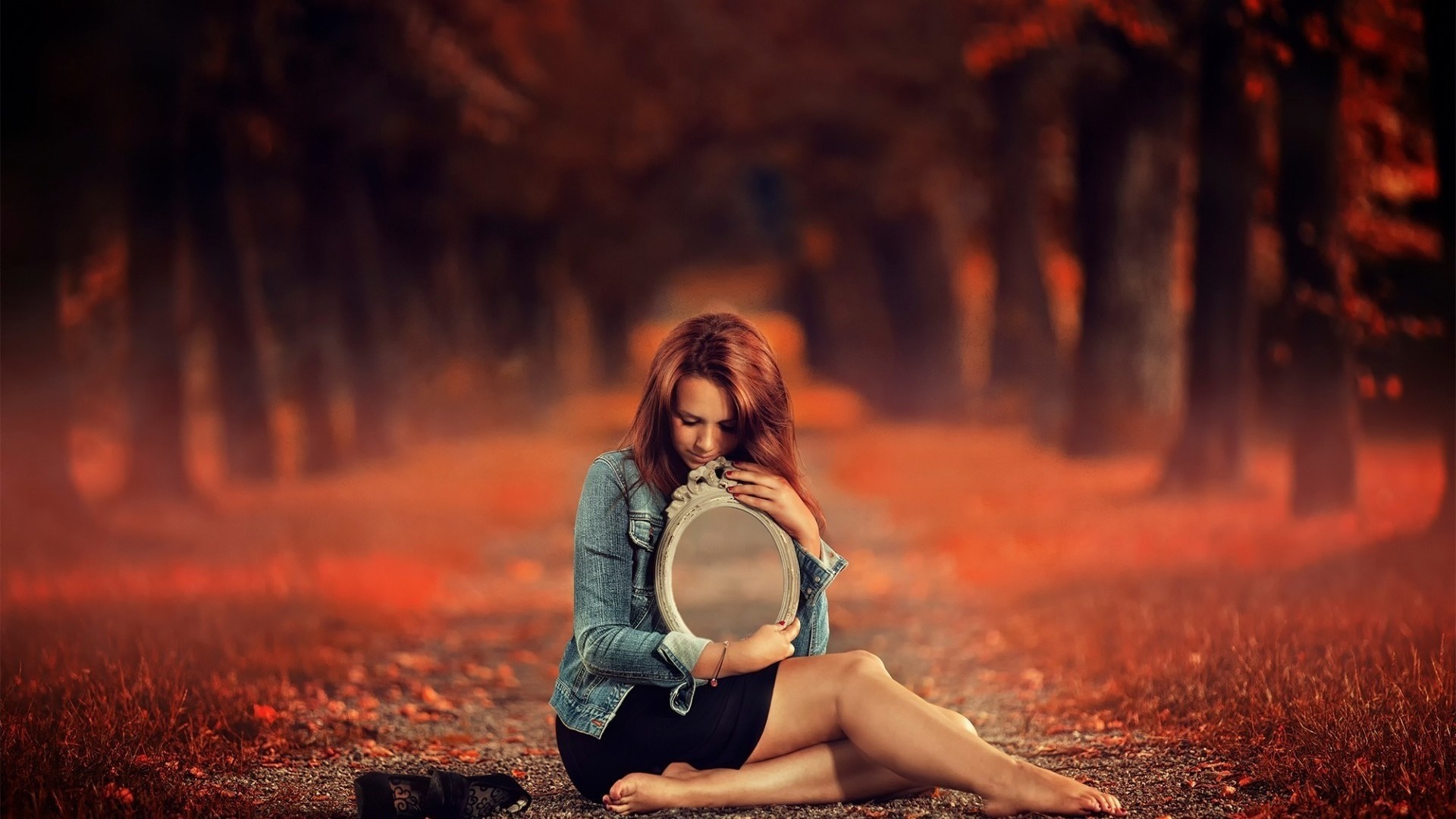 Woman holding a mirror in an autumn forest HD Wallpaper