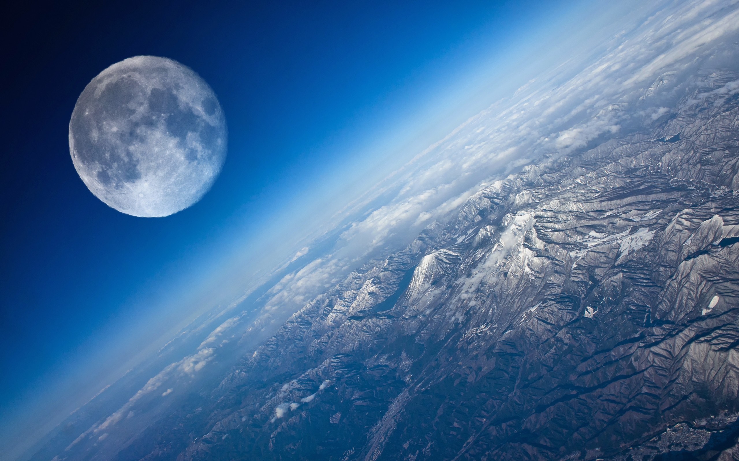 The Moon over snow-capped mountains from space HD Wallpaper