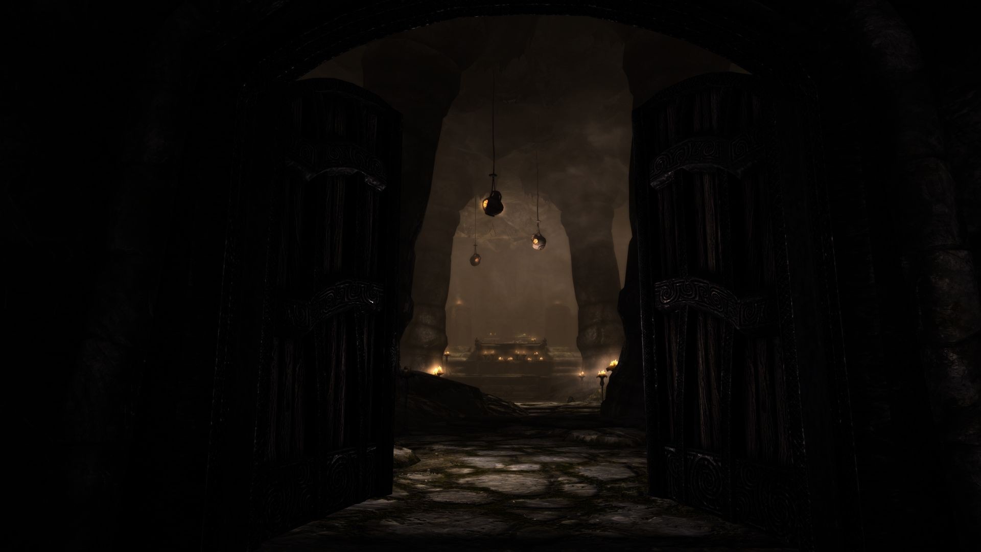 The Elder Scrolls V Skyrim cave entrance with hanging lanterns HD Wallpaper