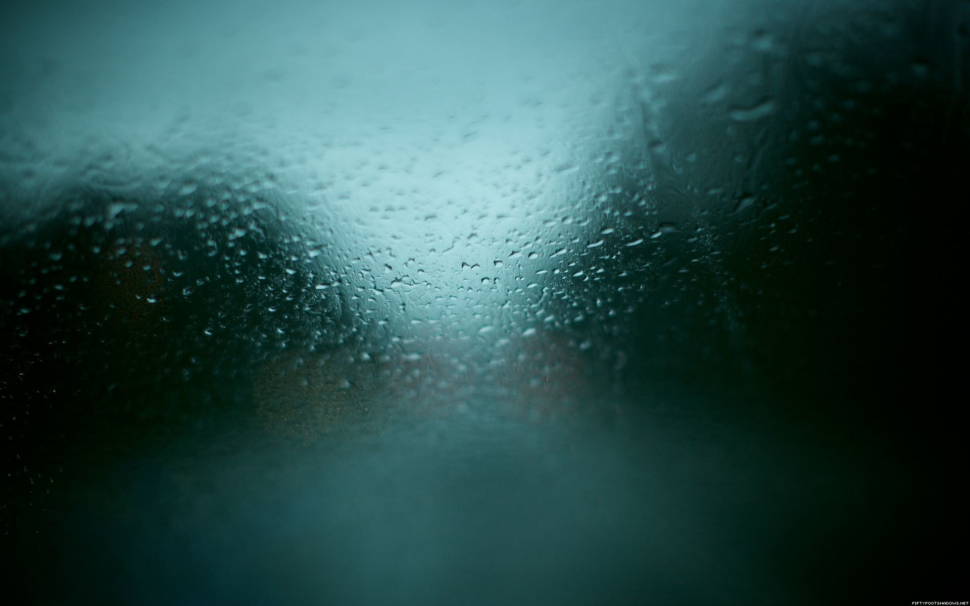 Raindrops on glass with blurred background HD Wallpaper