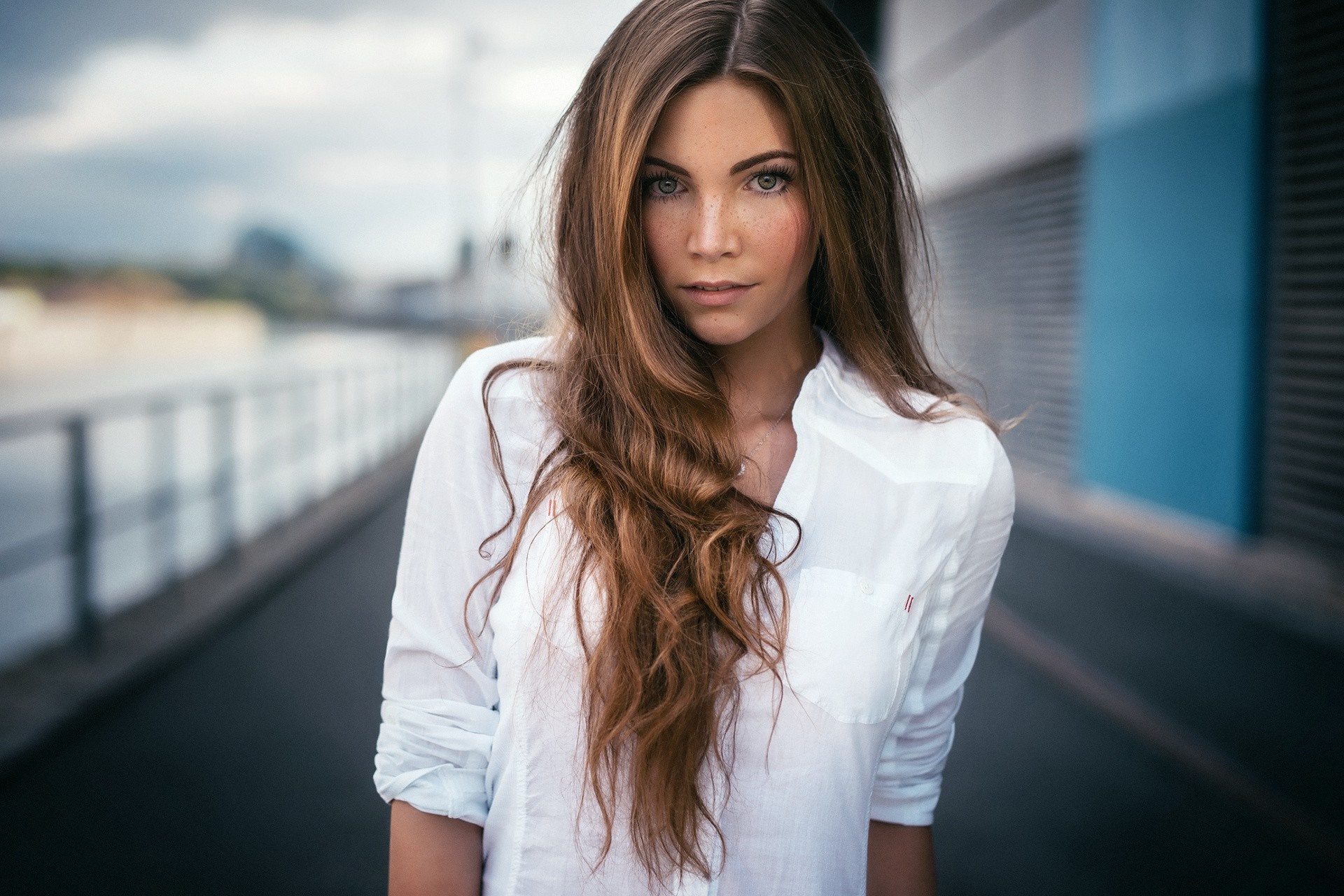 Woman with long brown hair and freckles wearing a white shirt HD Wallpaper