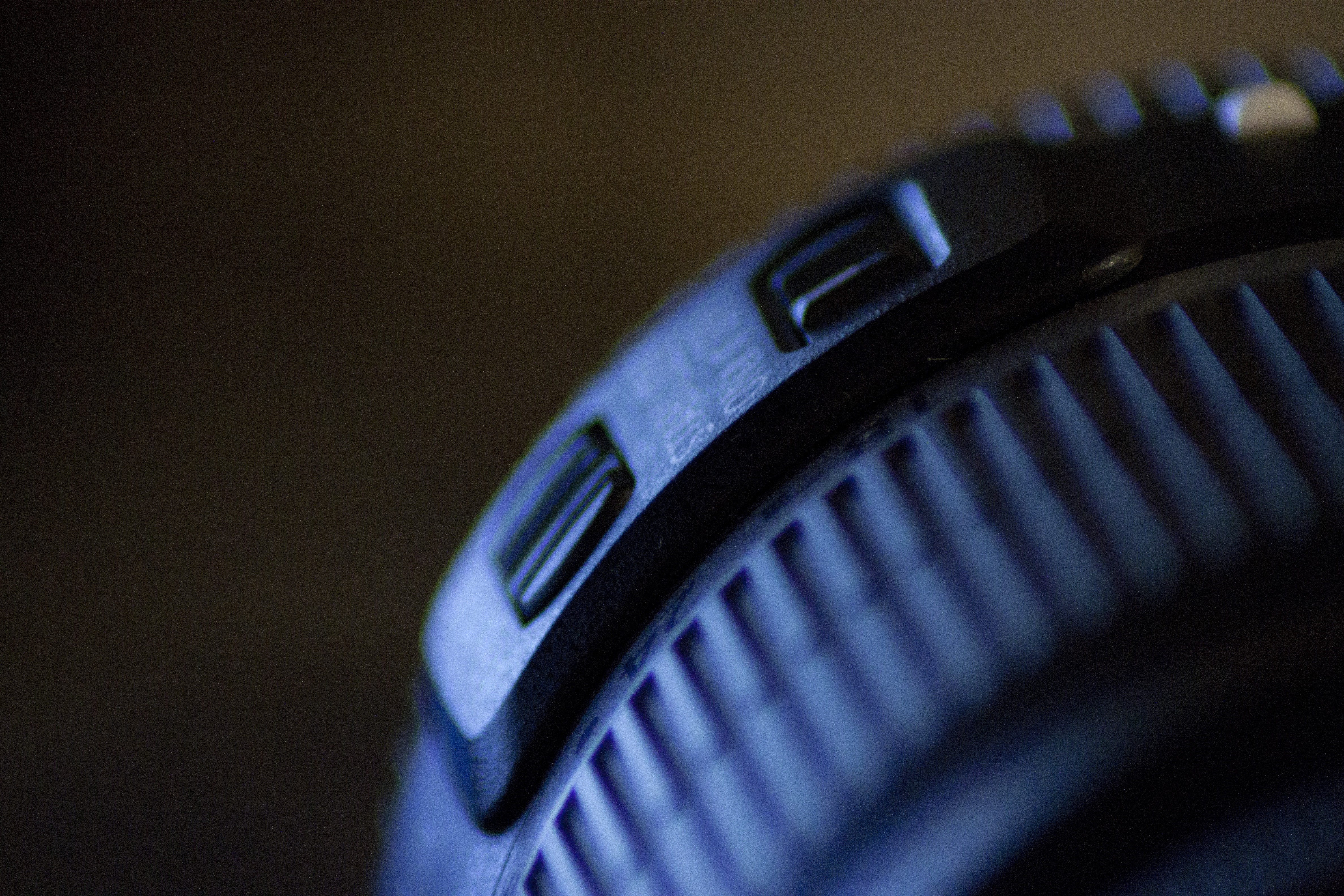 Close-up of a black electronic device with blue lighting HD Wallpaper