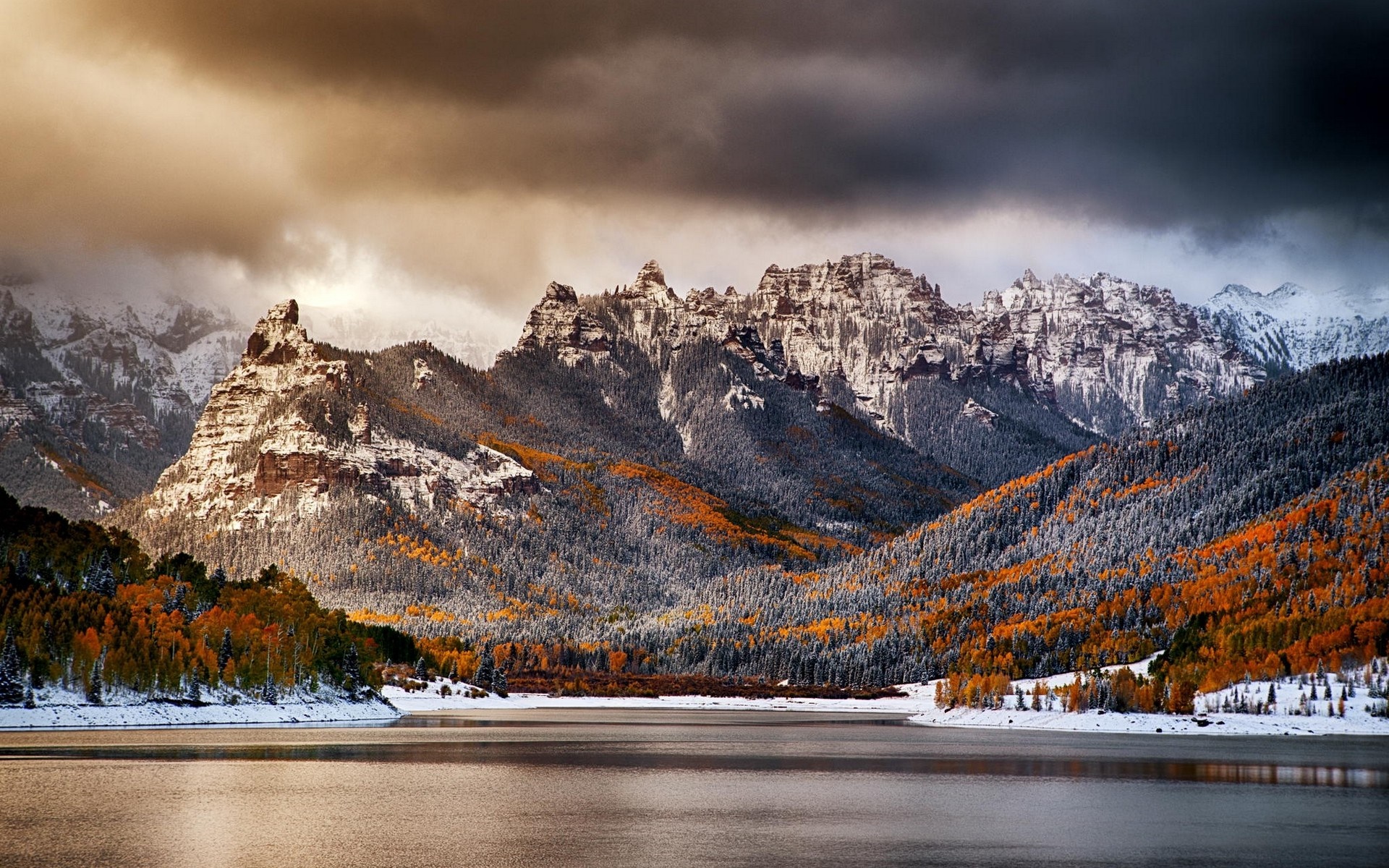 Snow-dusted mountains and autumn forest by a lake HD Wallpaper