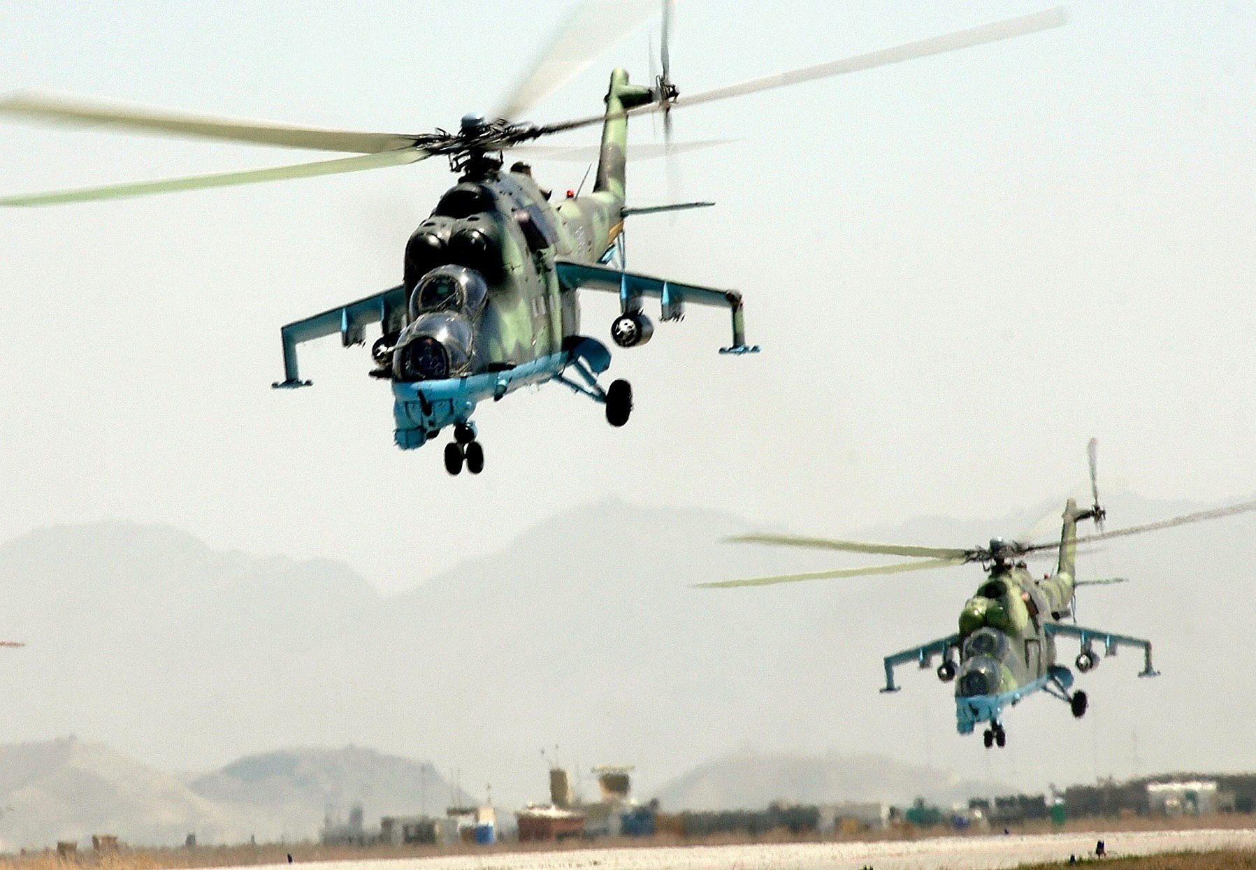 Two Mil Mi-24 Hind helicopters in flight HD Wallpaper