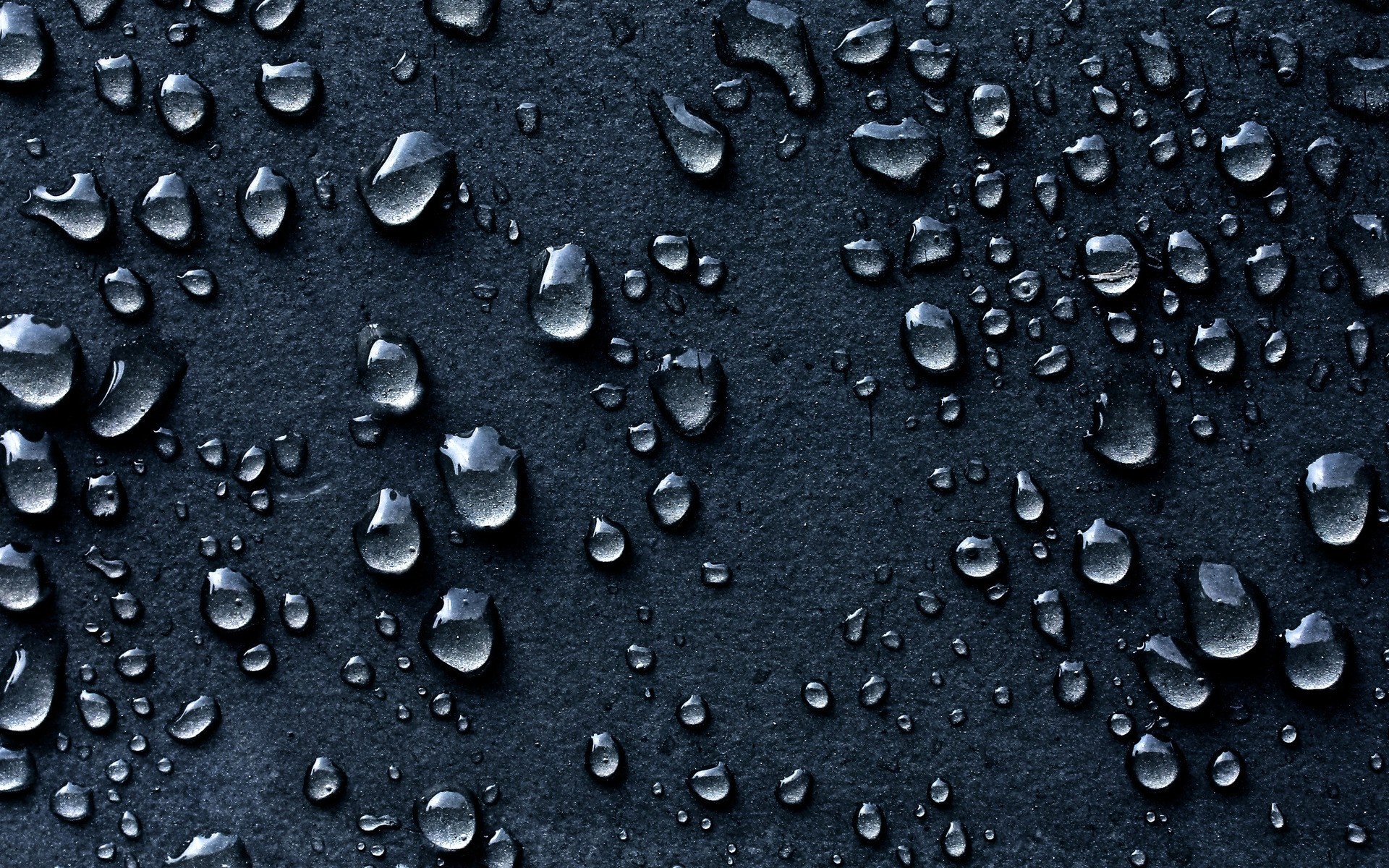 Water drops on a dark textured surface HD Wallpaper