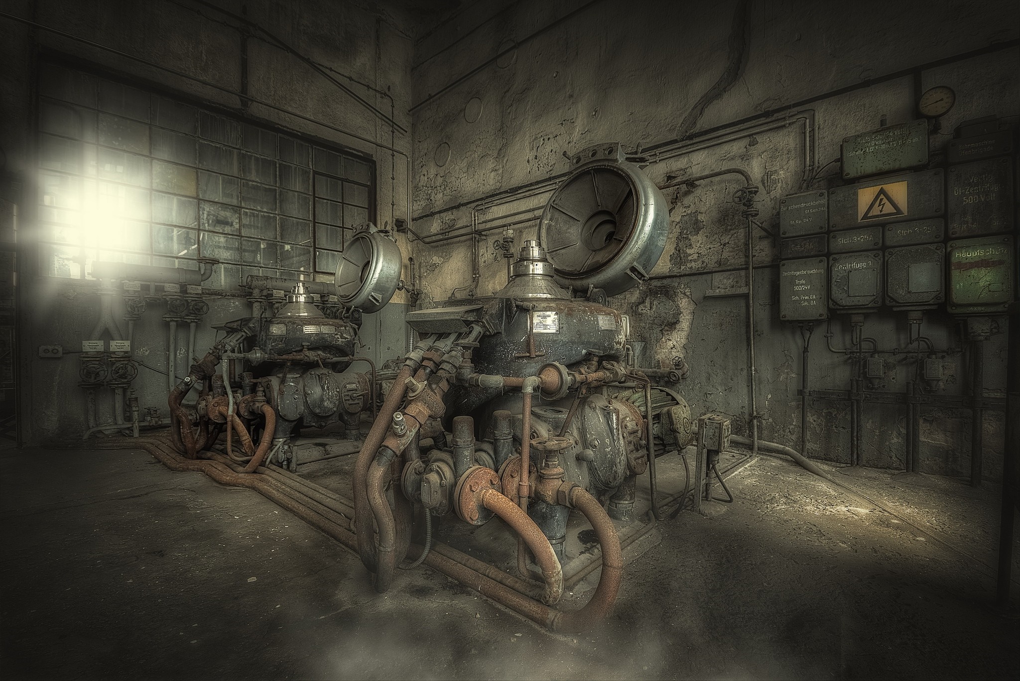 Abandoned industrial machinery in a dark factory HD Wallpaper