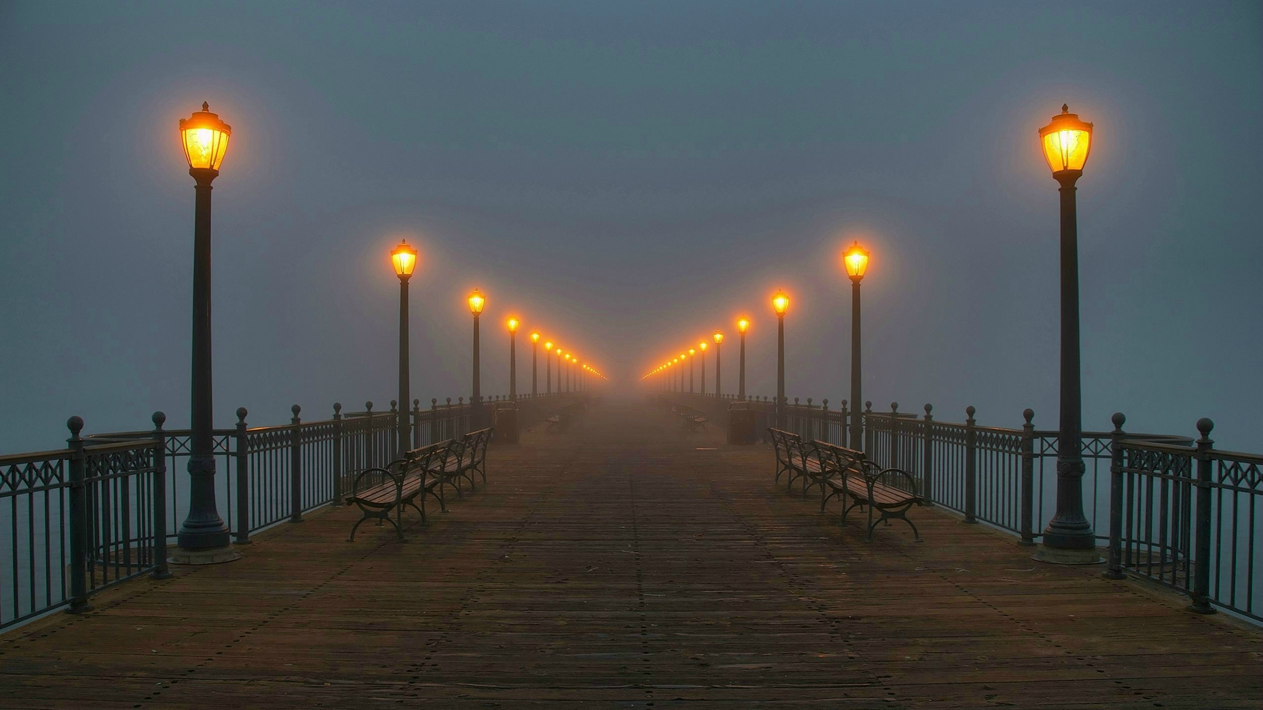 Pier with street lights in fog HD Wallpaper