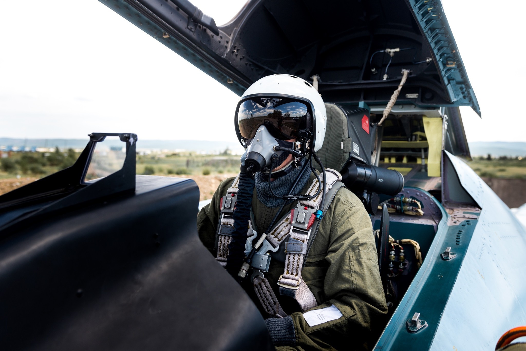 Pilot in a fighter jet cockpit with oxygen mask HD Wallpaper