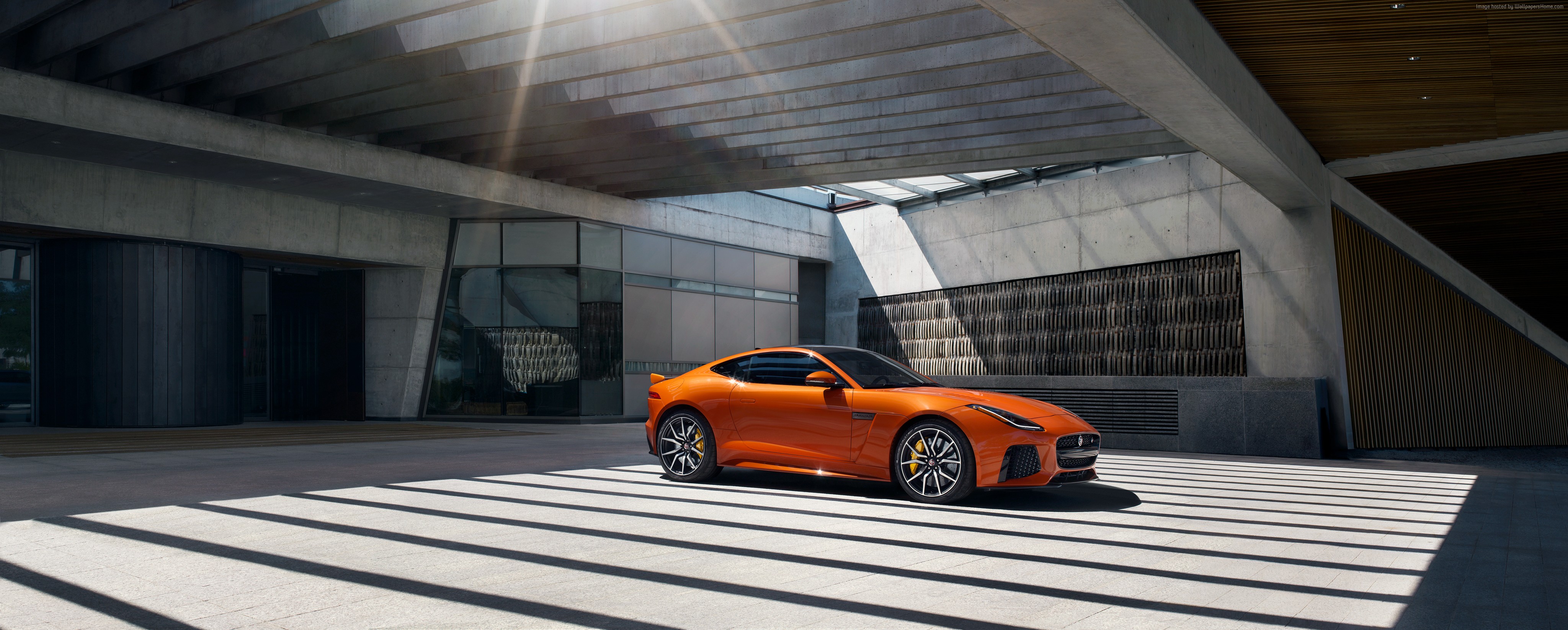 Orange Jaguar F-Type SVR parked under a modern building HD Wallpaper