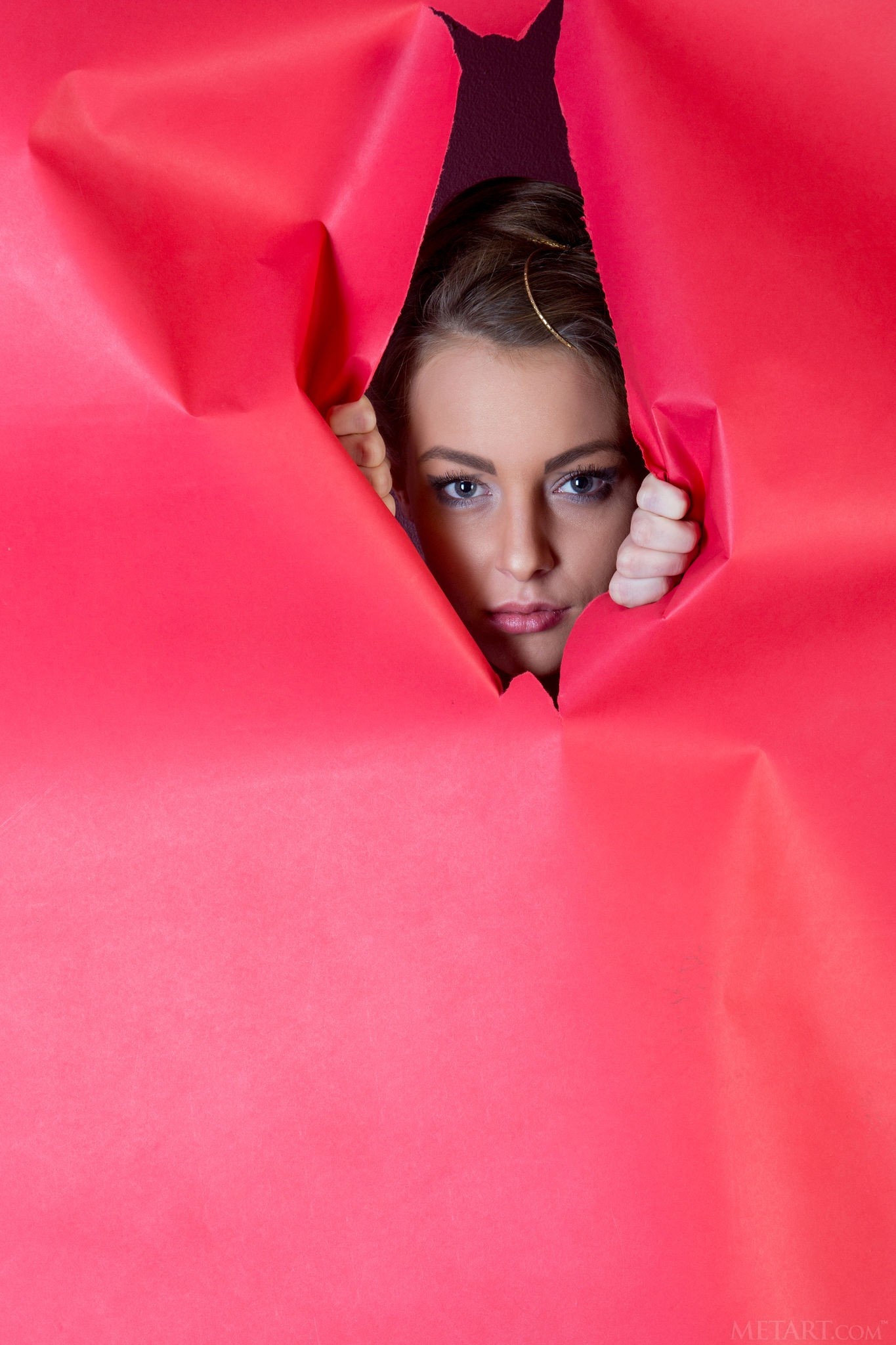 Model Peeking Through Torn Red Paper HD Wallpaper