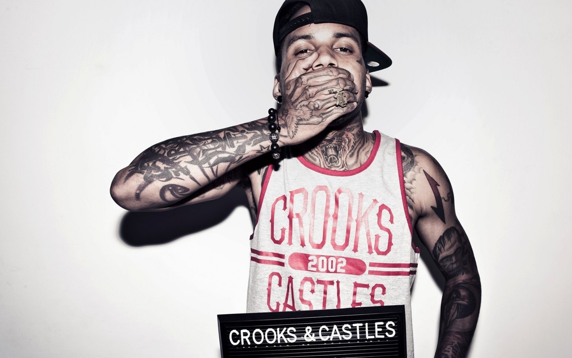 Man with tattoos and Crooks & Castles shirt HD Wallpaper