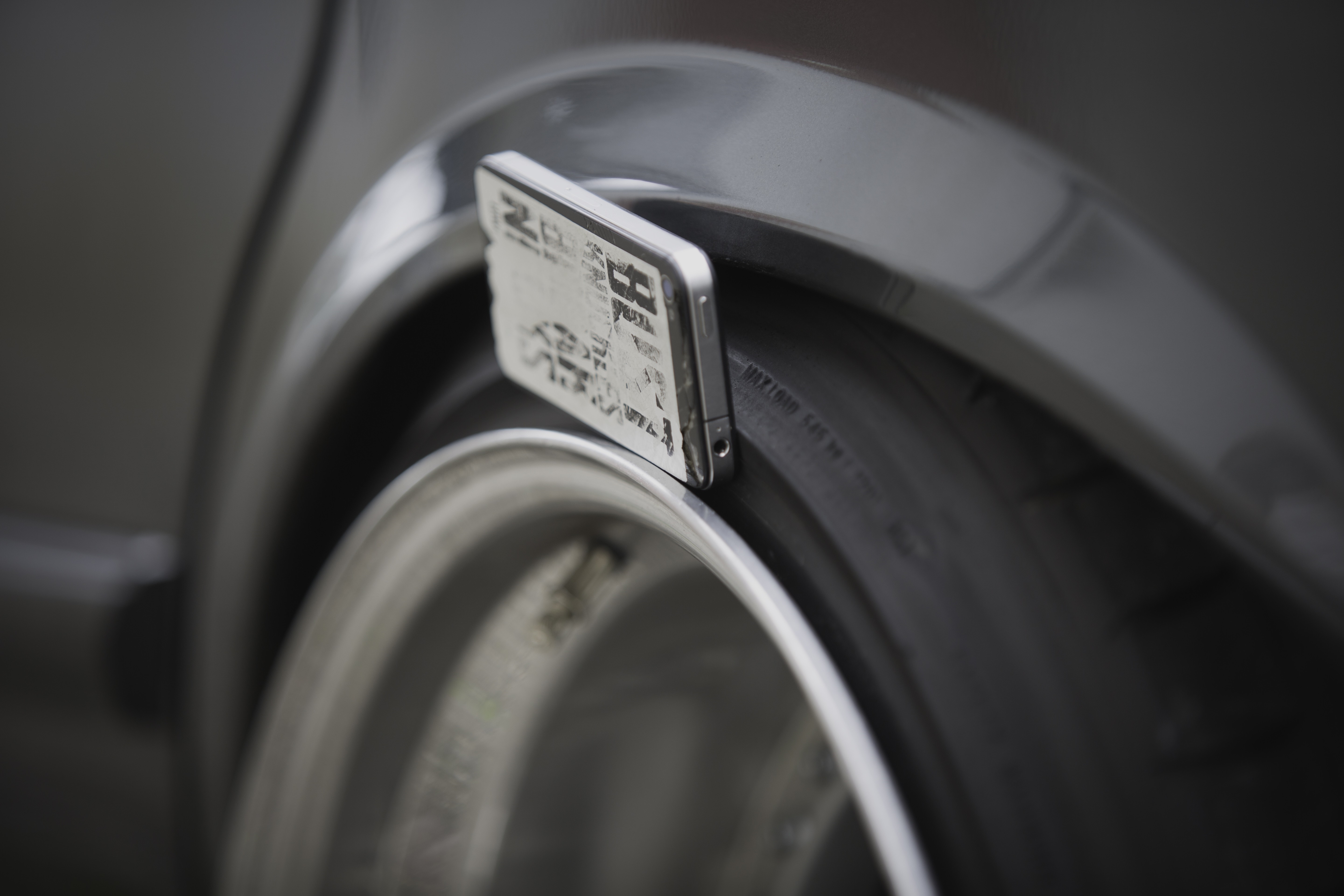 Close-up of a car tire and rim with a sticker HD Wallpaper
