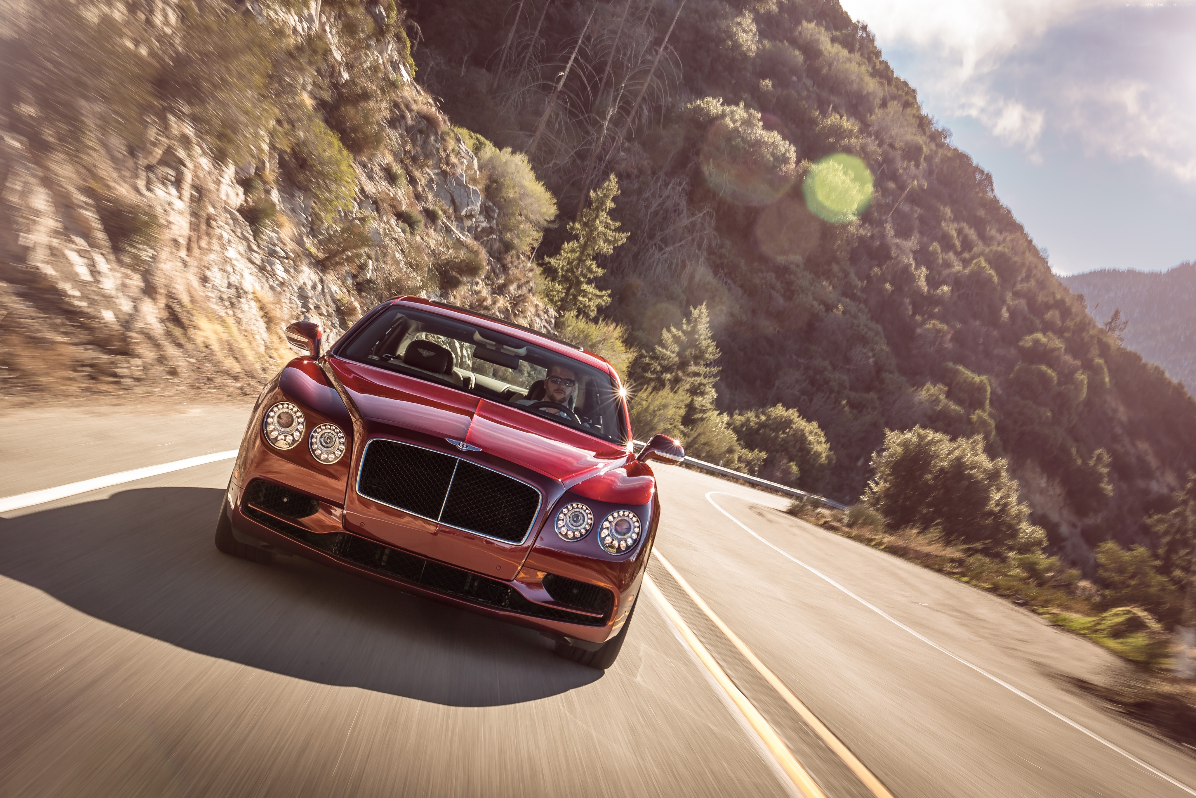 Red Bentley Flying Spur V8 S driving on a mountain road HD Wallpaper
