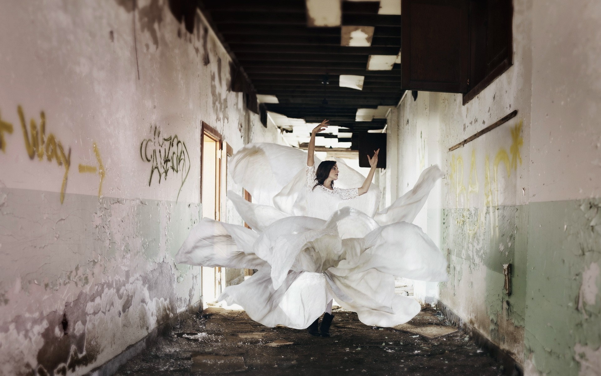 Woman in white dress dancing in abandoned hallway HD Wallpaper