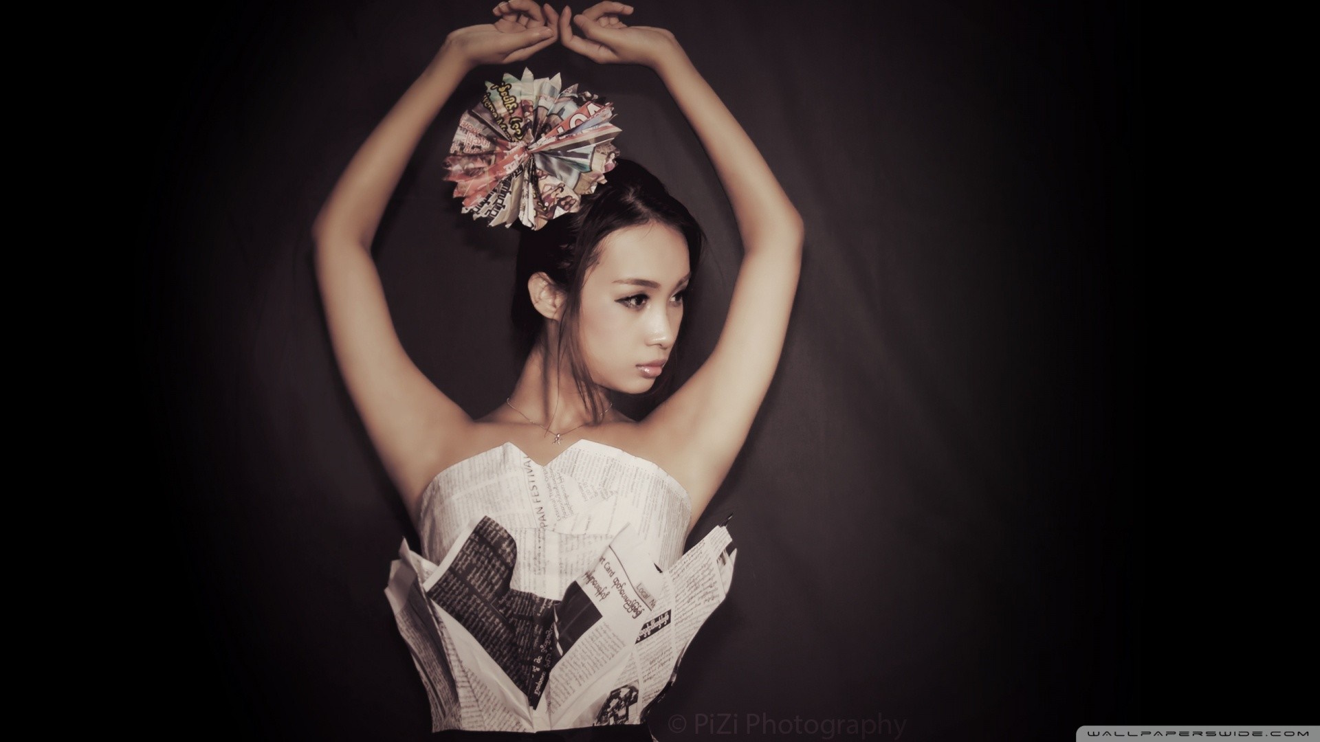 Asian woman in newspaper dress and headdress HD Wallpaper