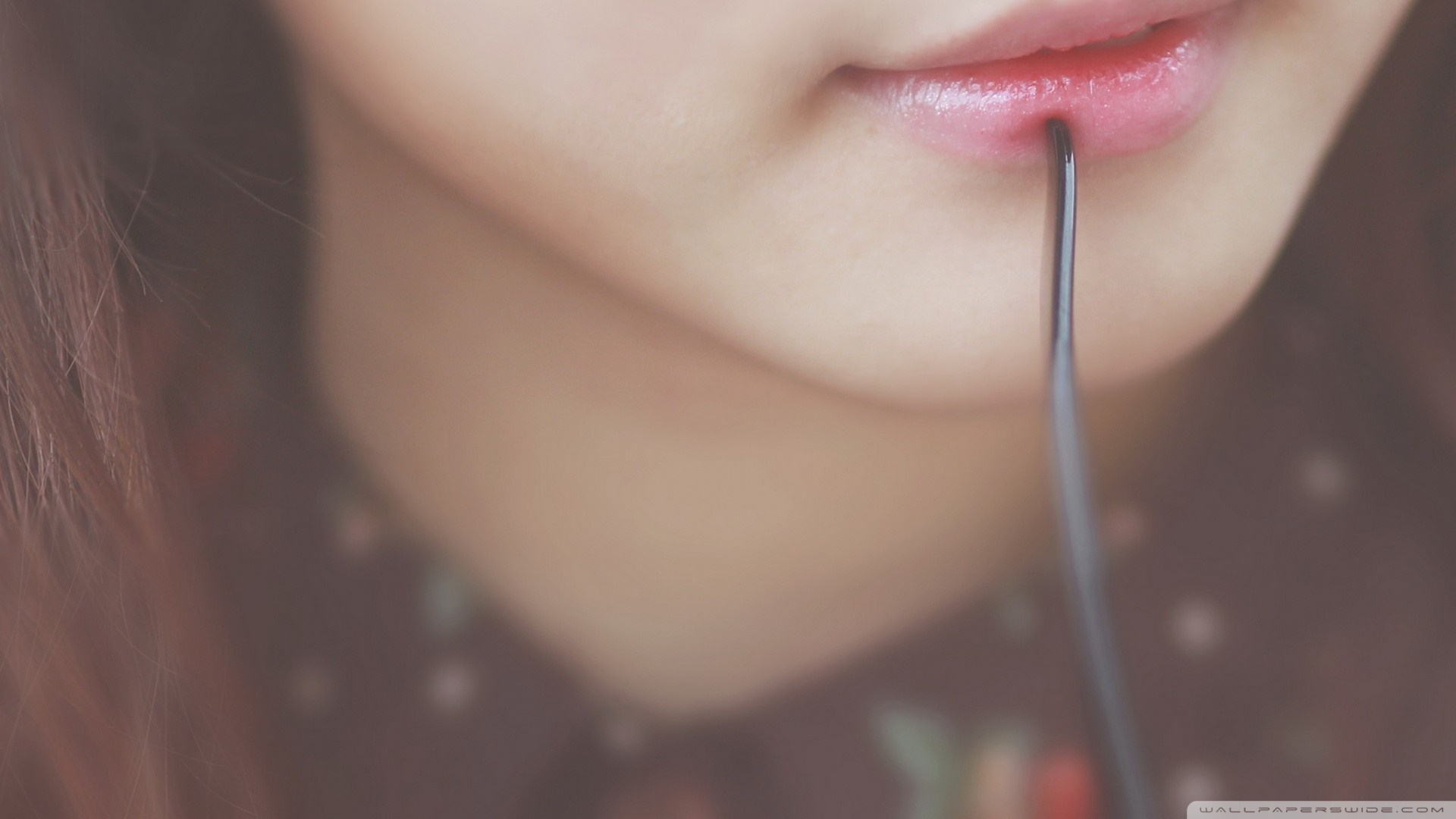 Close up of a woman's lips with a metal object HD Wallpaper