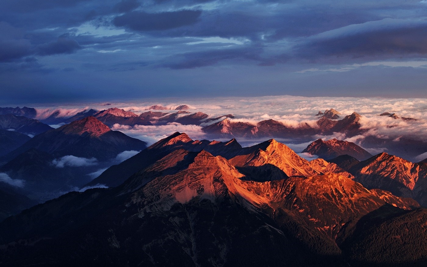 Mountain range at sunset with clouds and dramatic sky HD Wallpaper