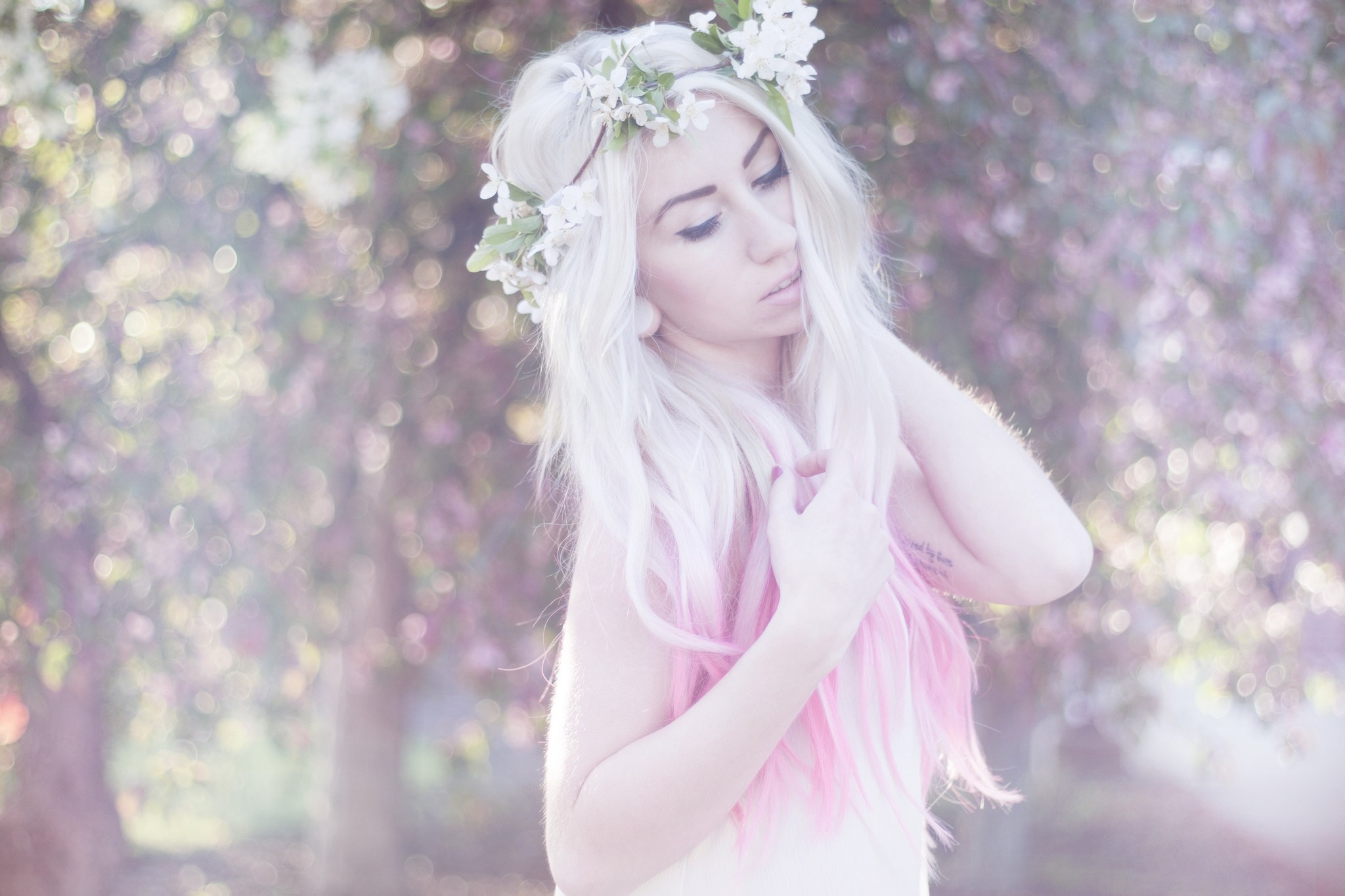 Woman with flower crown and pink hair outdoors HD Wallpaper
