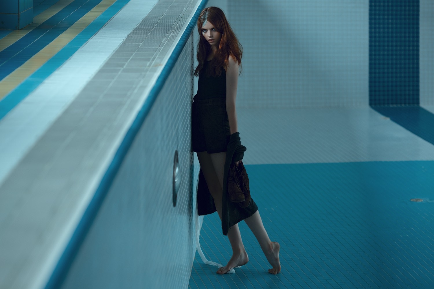 Model in black dress by empty swimming pool HD Wallpaper