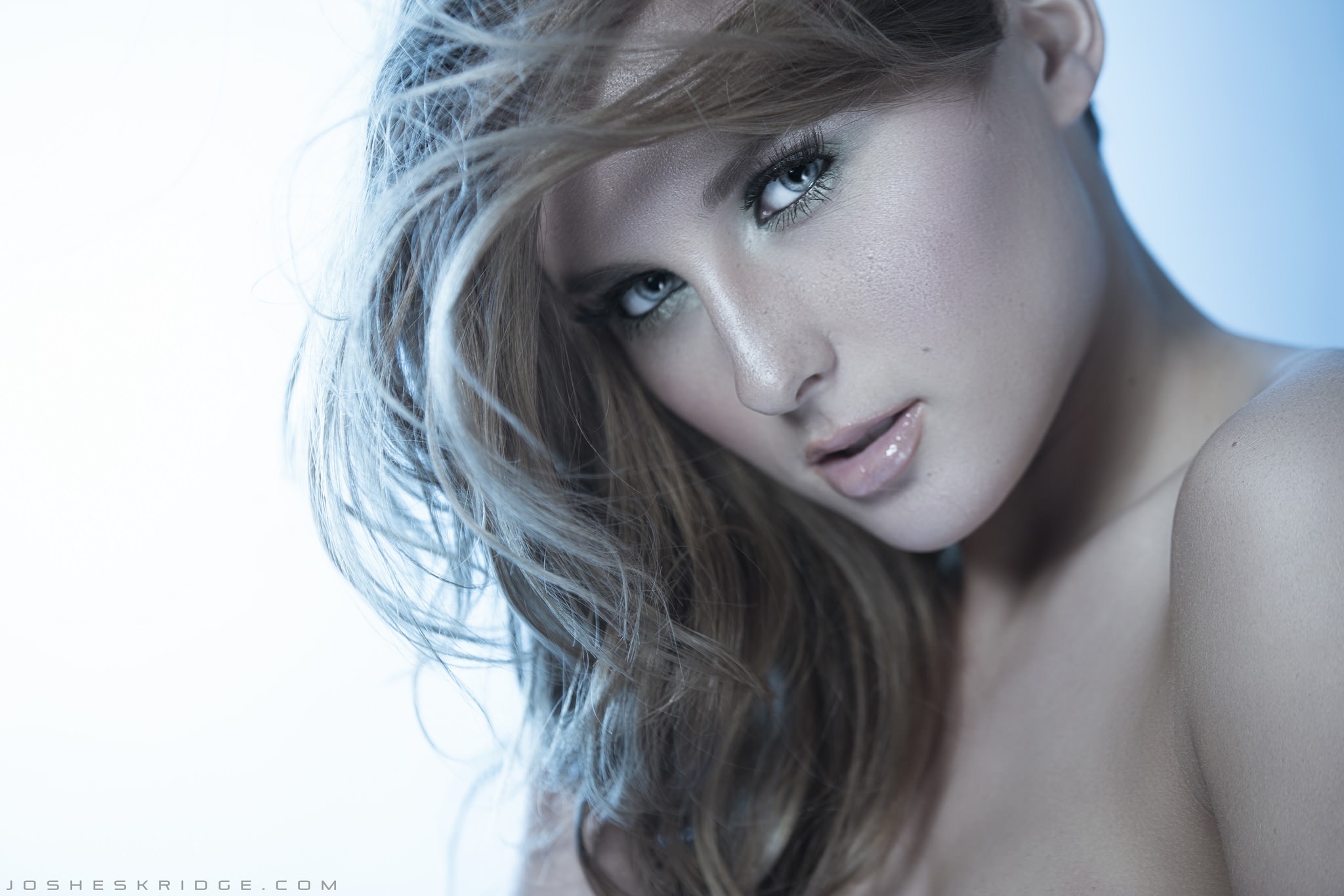 Woman with flowing hair in a close-up portrait HD Wallpaper