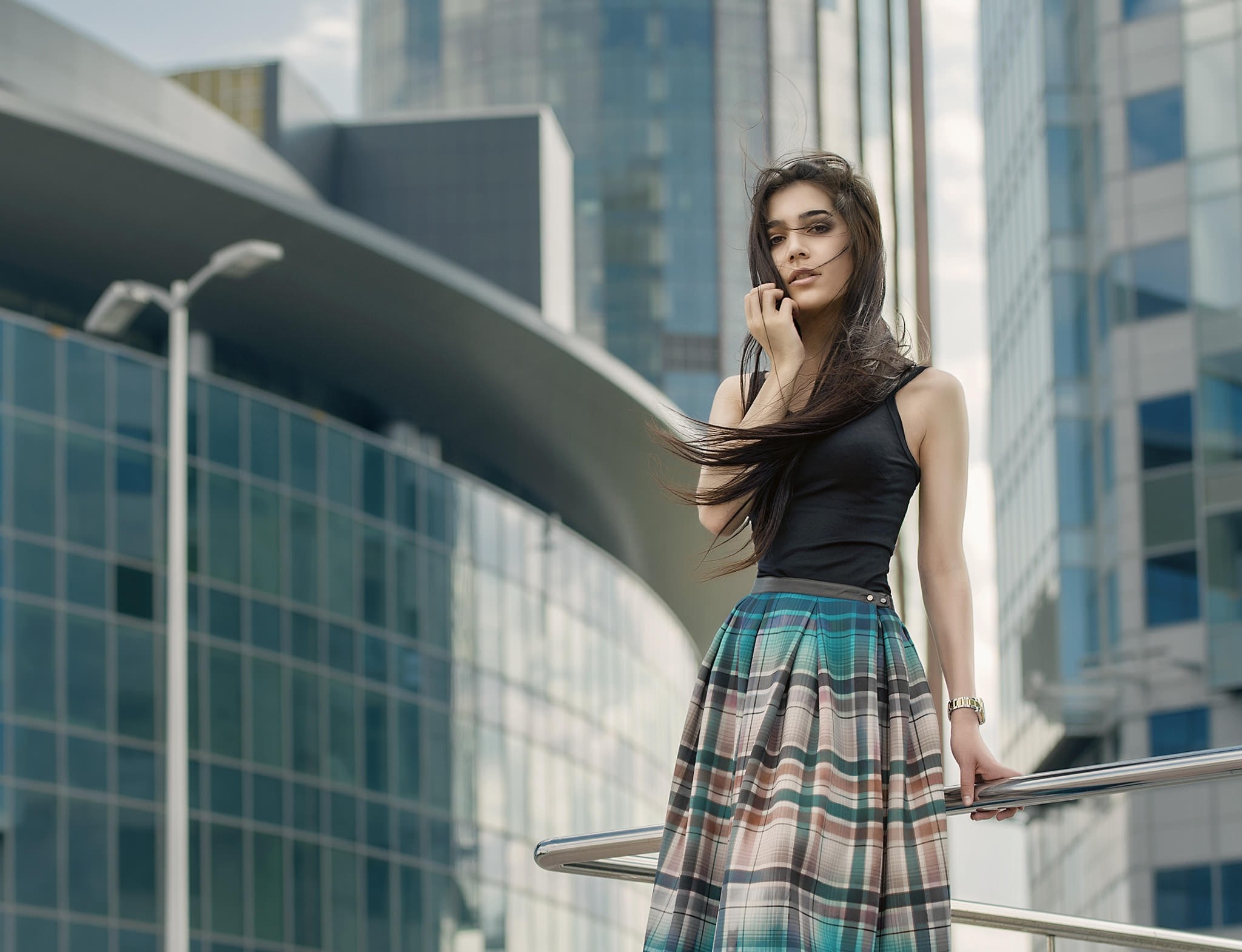 Woman in plaid skirt and black top outdoors HD Wallpaper