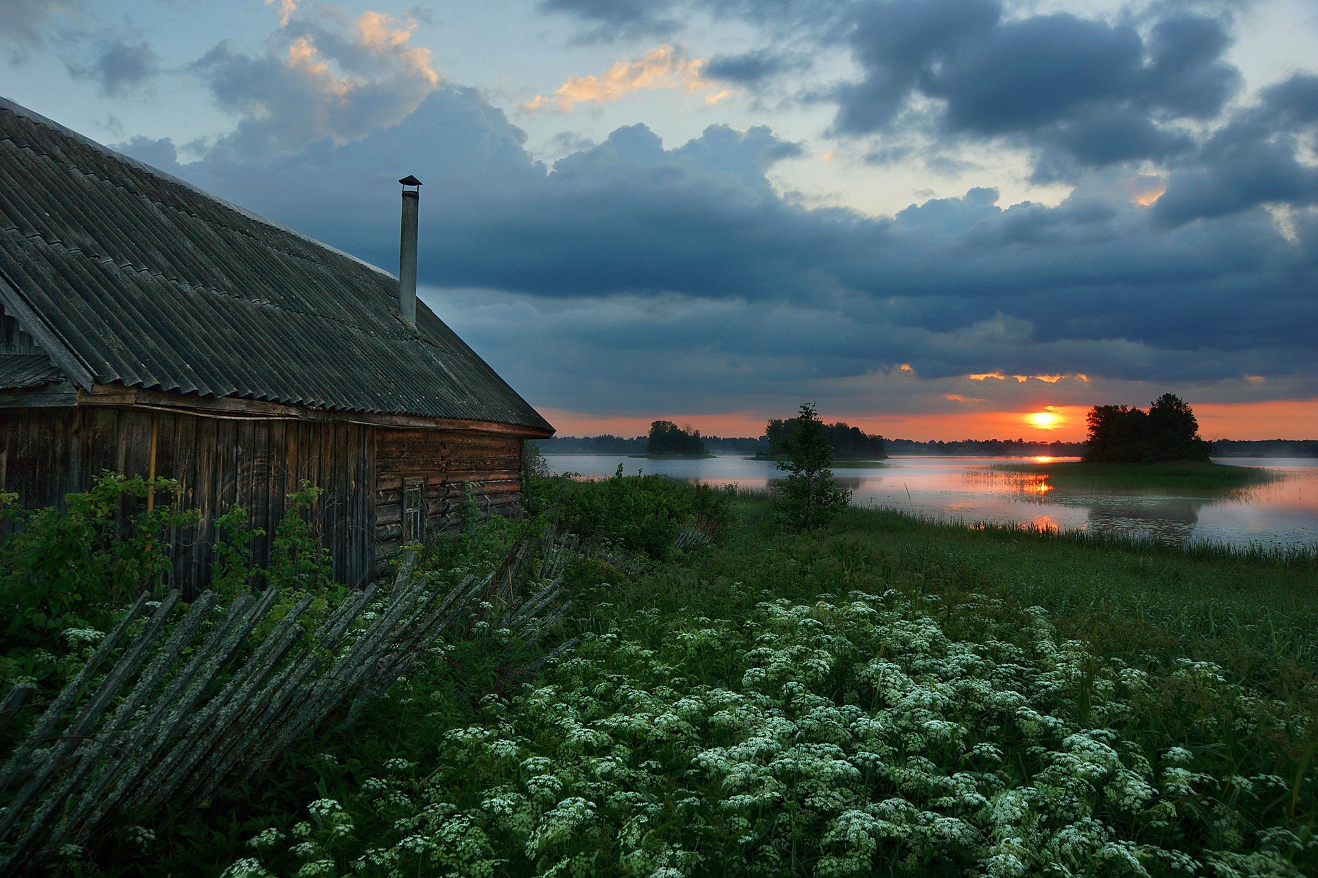 Wooden house by a lake at sunset HD Wallpaper
