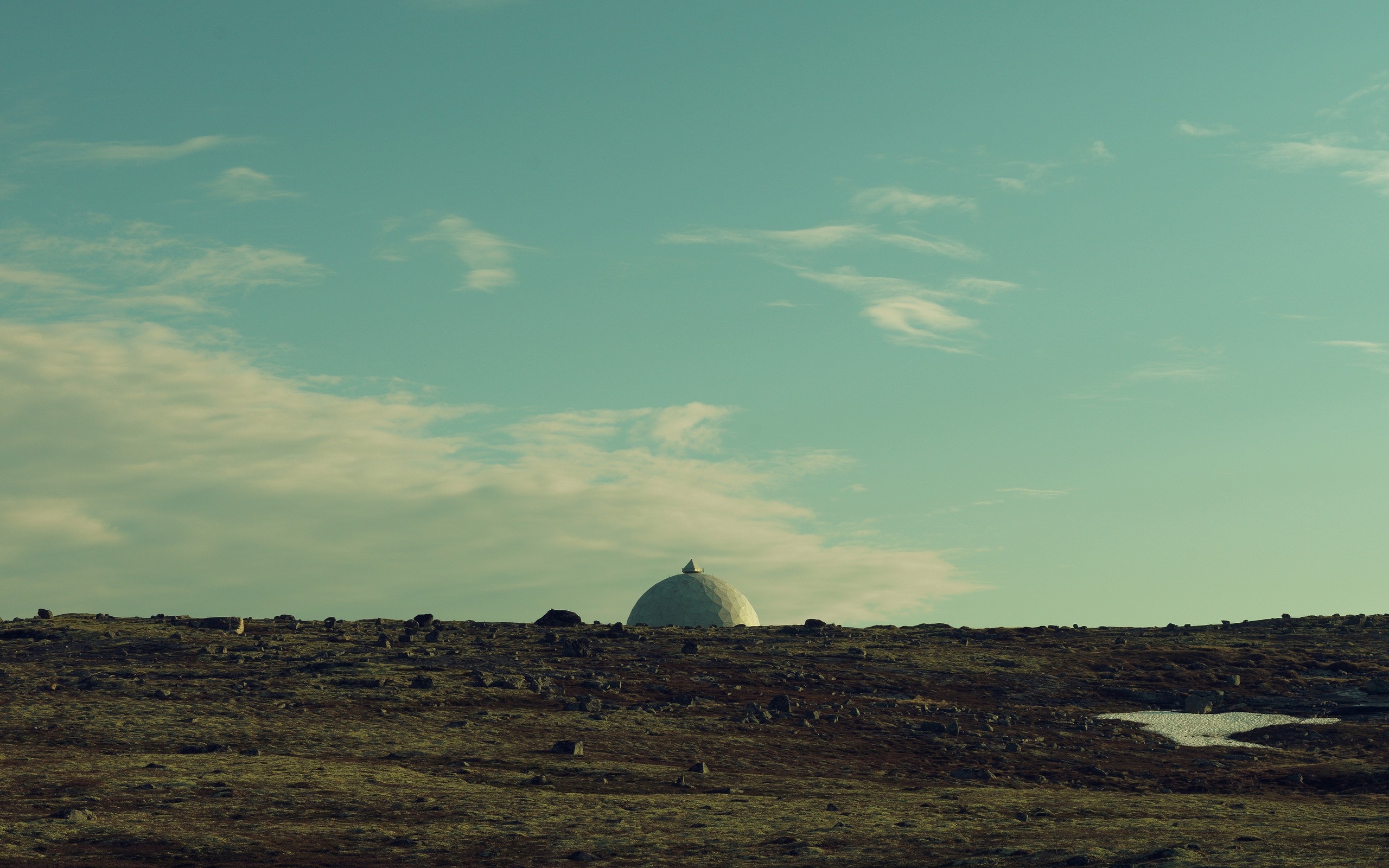 Dome building on a rocky hill under a cloudy sky HD Wallpaper