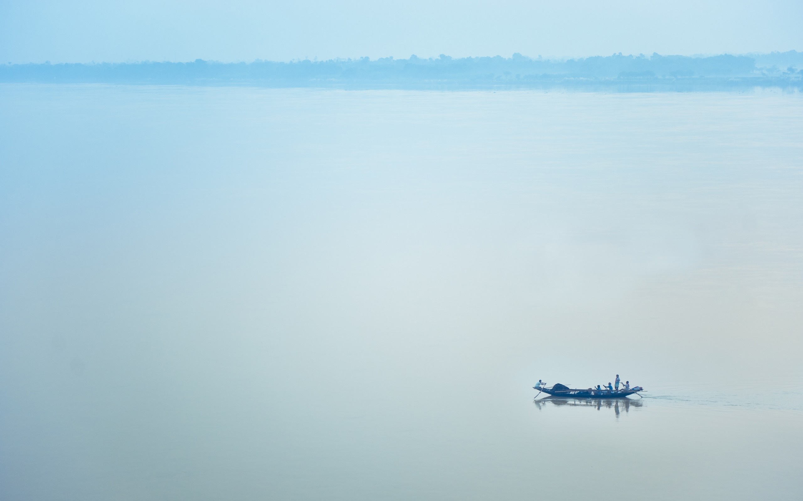 Boat with people on a misty river at dawn HD Wallpaper