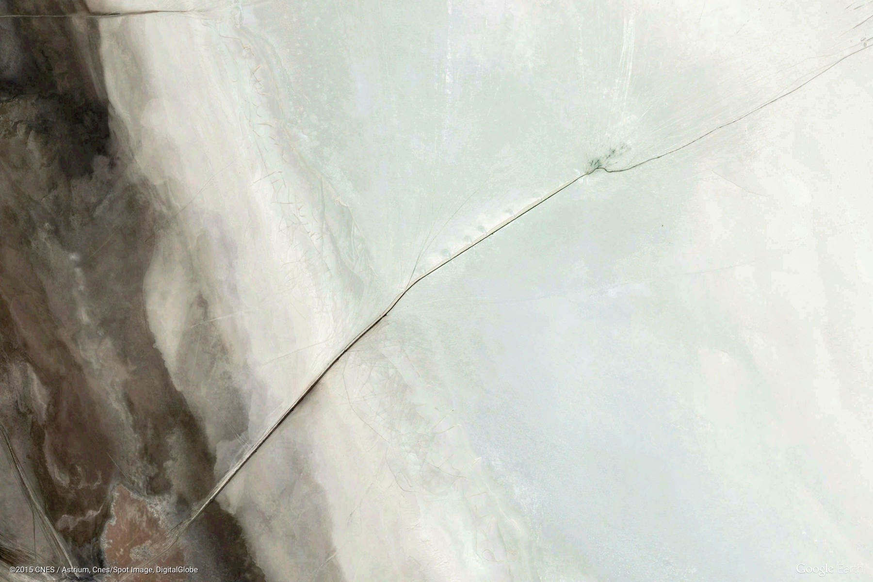 Aerial view of a cracked, dry landscape HD Wallpaper