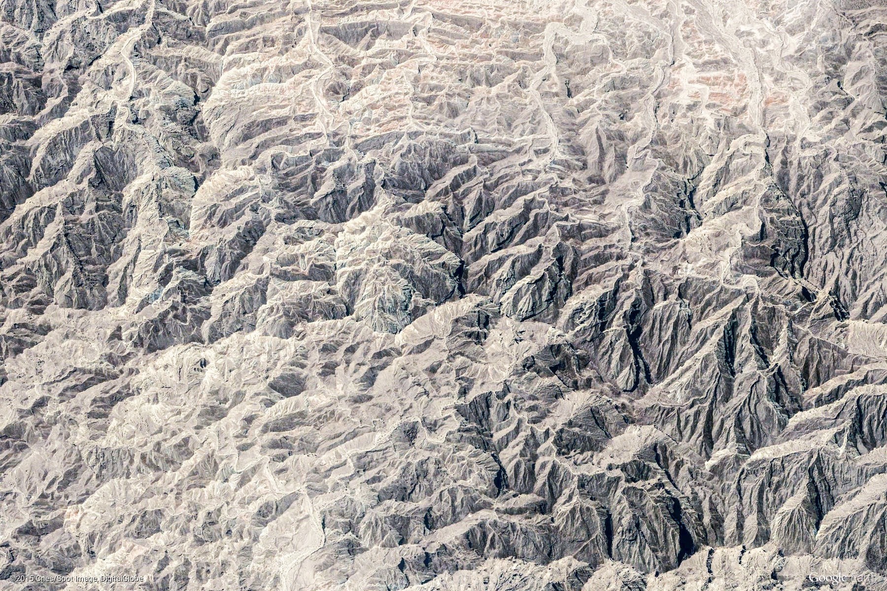 Aerial view of rugged, eroded mountain range HD Wallpaper