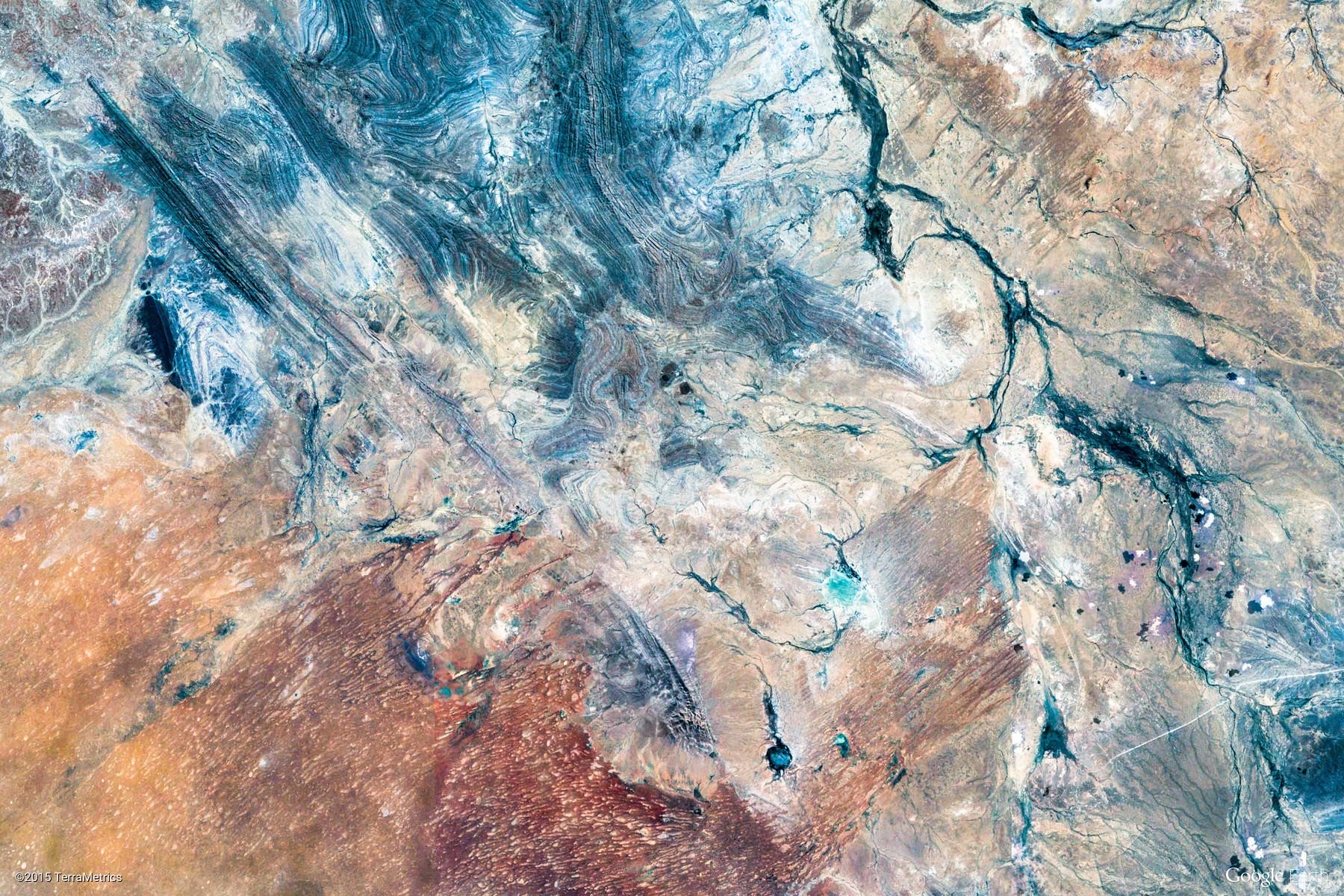 Aerial view of geological formations and water bodies HD Wallpaper