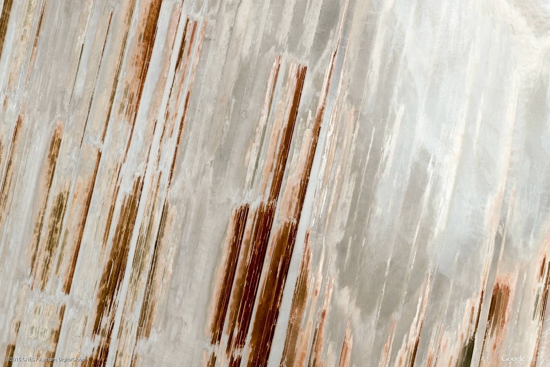 Aerial view of geological formations with brown and white stripes HD Wallpaper