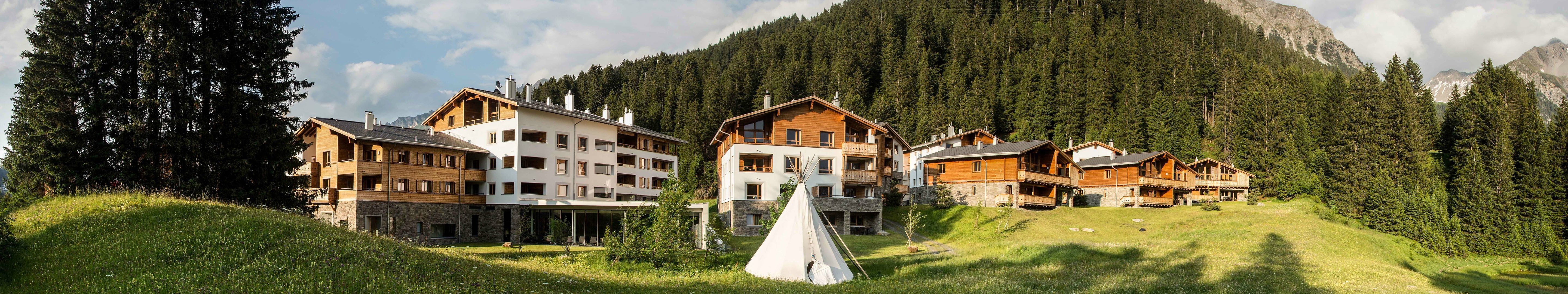 Mountain village with hotels and a teepee HD Wallpaper