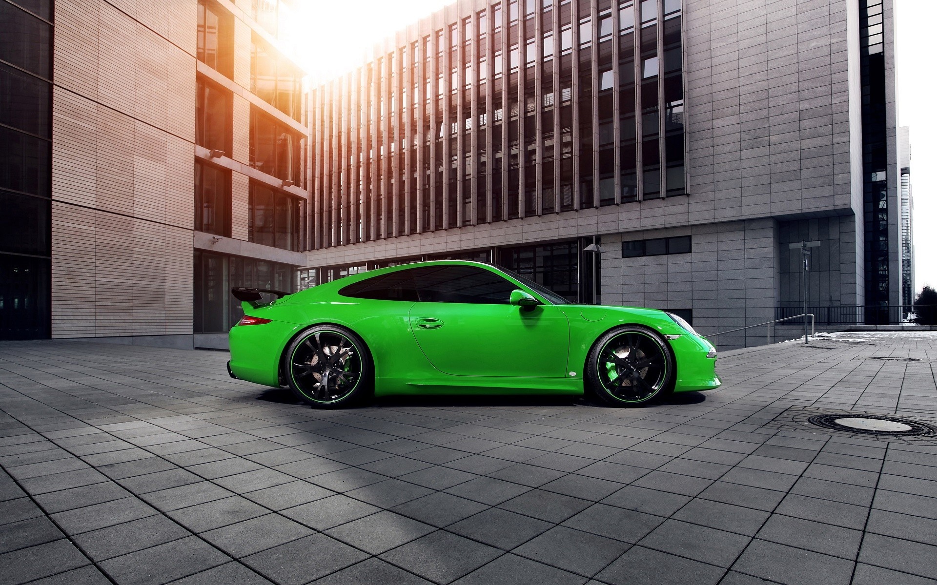 Green Porsche 911 Carrera 4S parked in front of a modern building HD Wallpaper