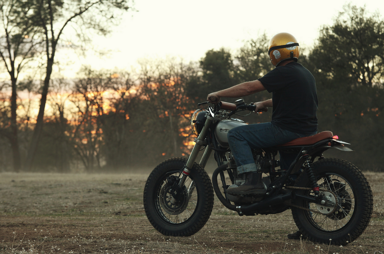Man in helmet riding a motorcycle at sunset HD Wallpaper
