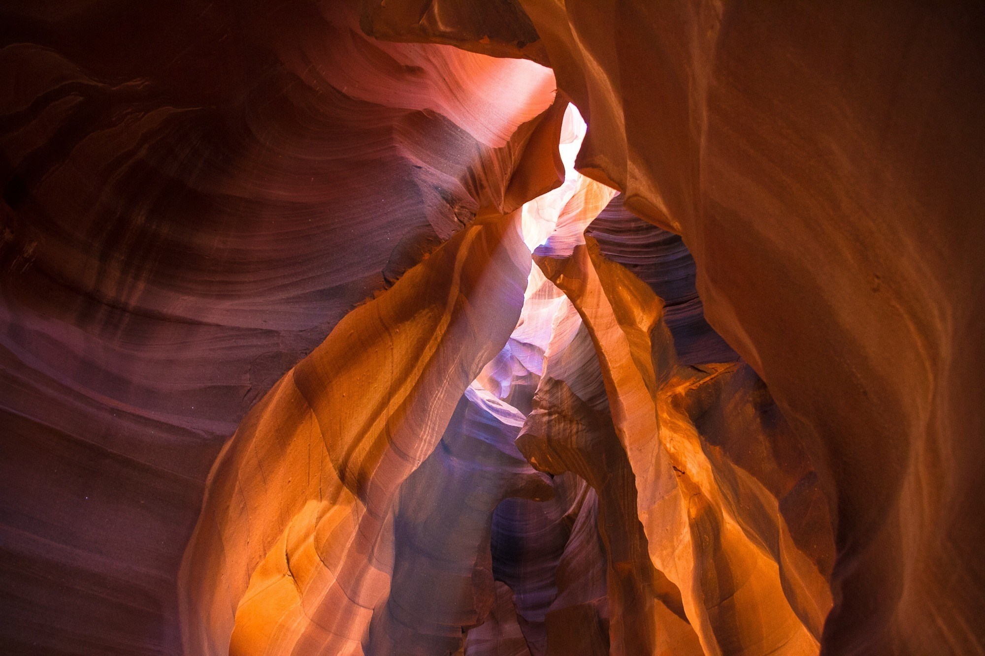 Sunlight filtering through a sandstone canyon HD Wallpaper