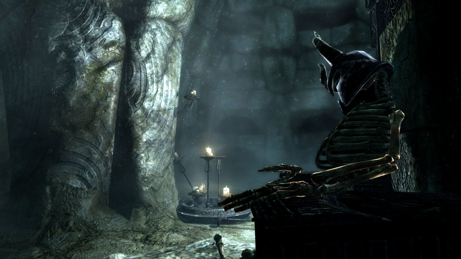 Skeleton in a dark tomb with candles in The Elder Scrolls V Skyrim HD Wallpaper