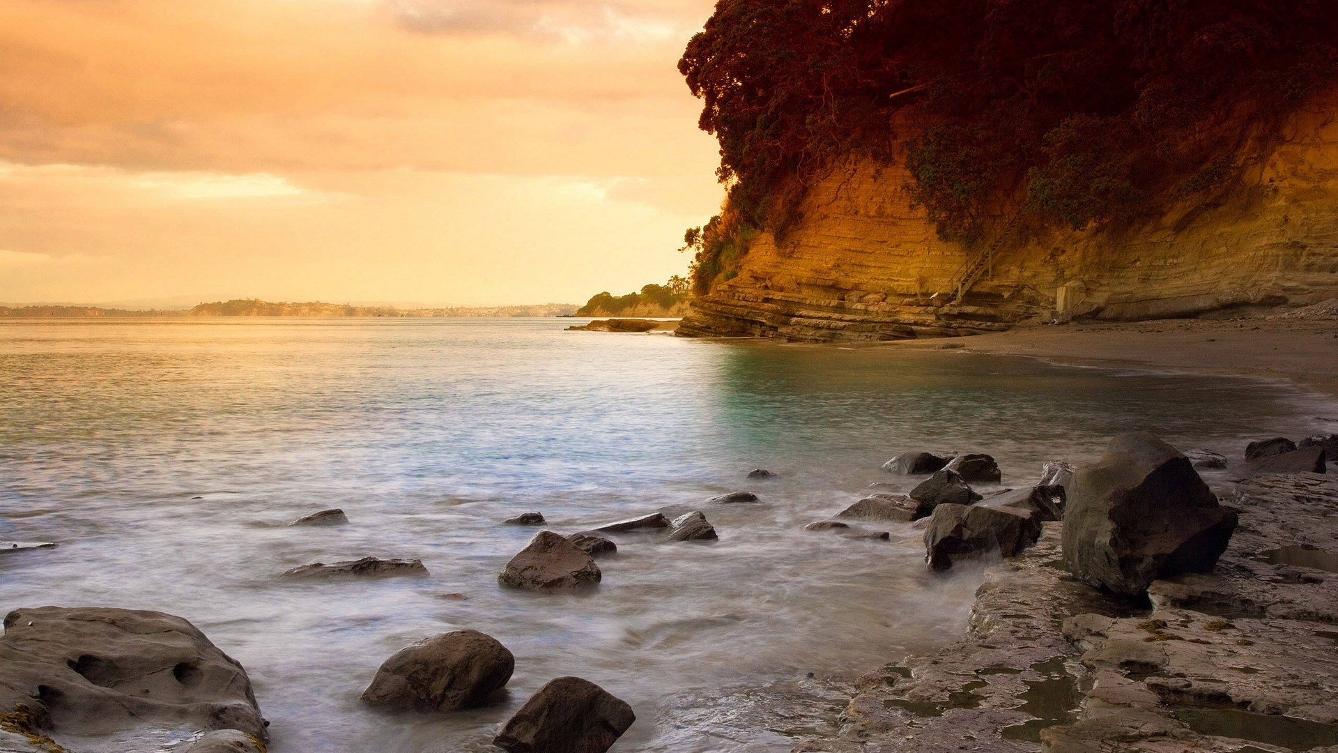 Rocky beach with cliff and ocean at sunset HD Wallpaper