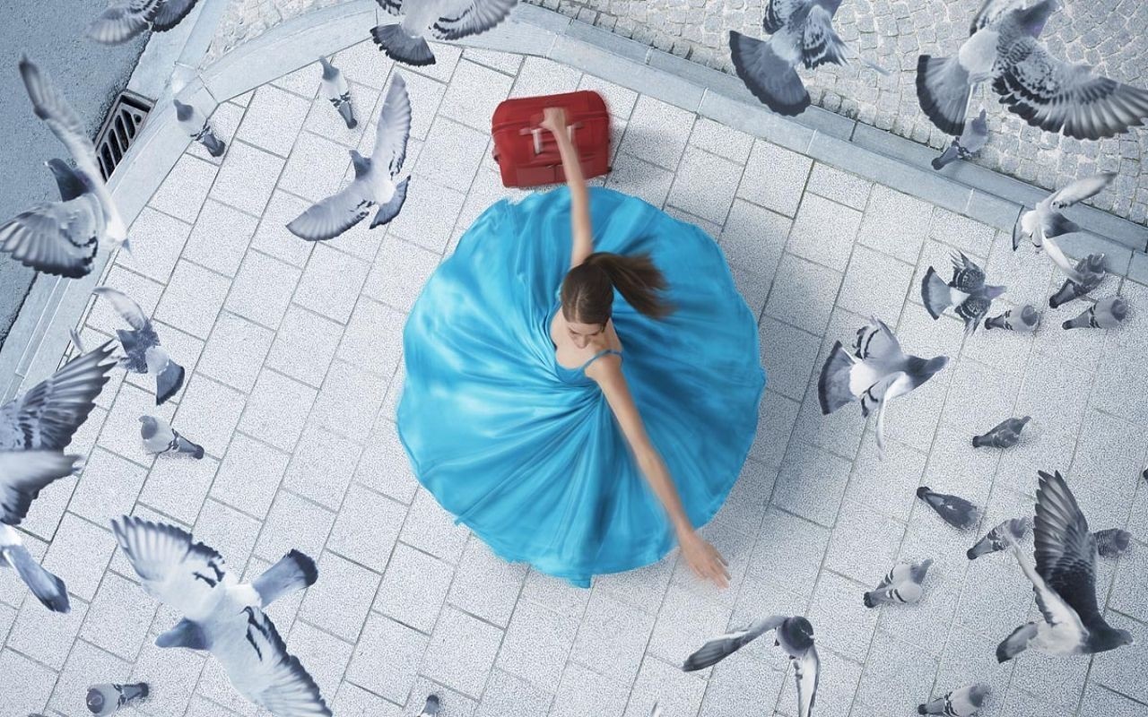 Woman in blue dress with pigeons and suitcase HD Wallpaper