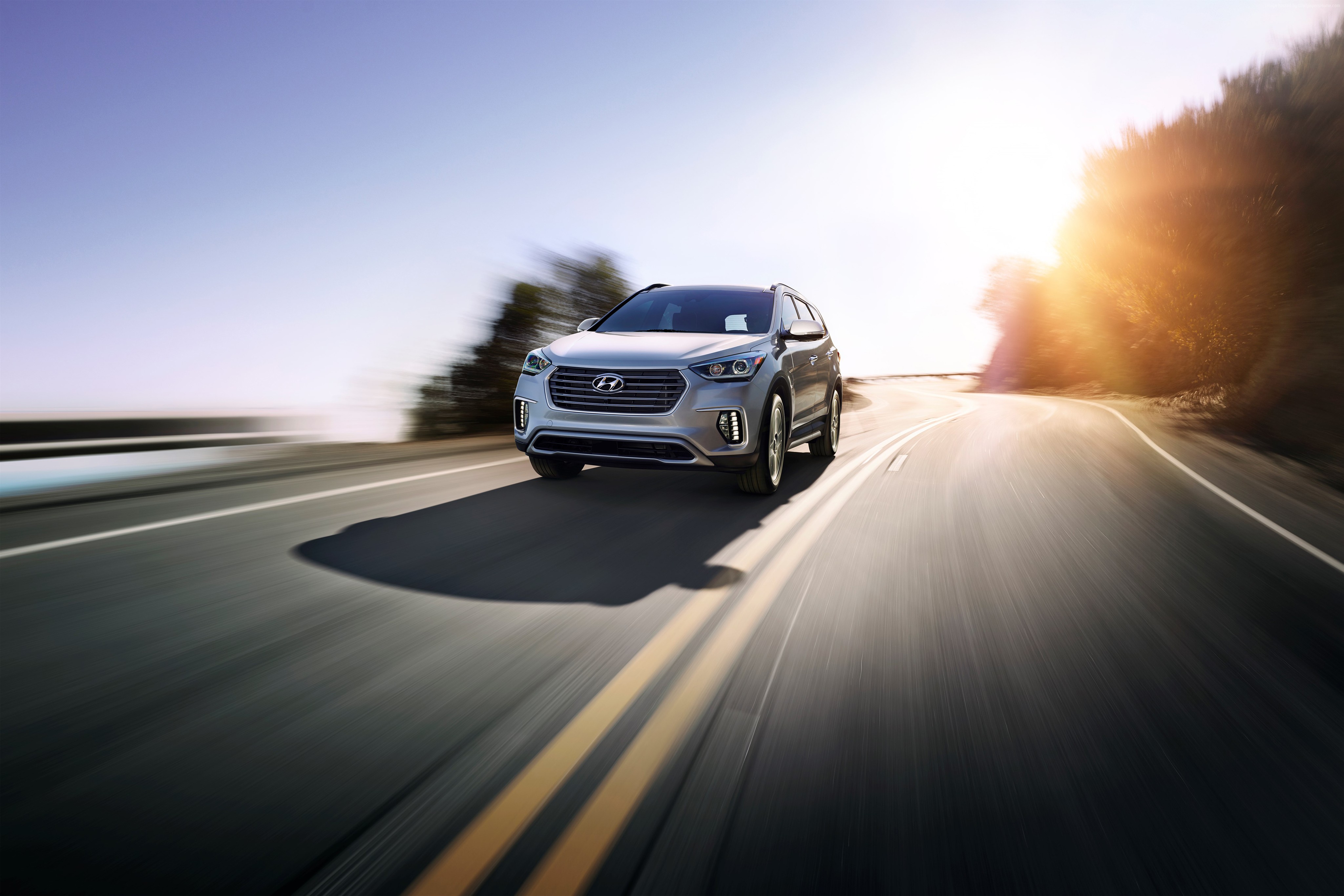 Hyundai Santa Fe driving on a sunny road HD Wallpaper